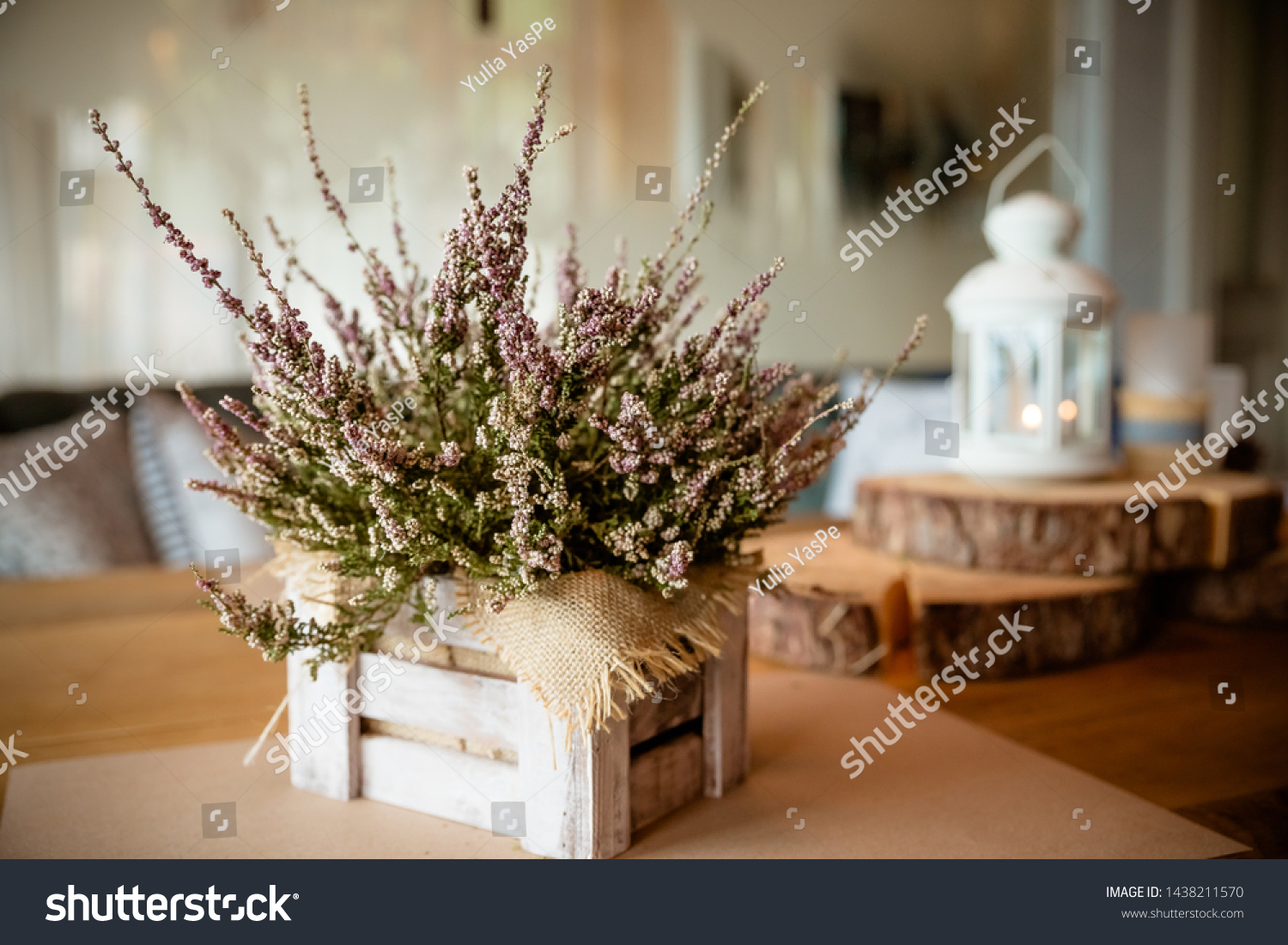 Basket with Heather on the table.heather in a basket . Autumn decorations.pink and purple flowers heather,heath in wooden box,autumn plants and lantern.country house. Seasonal decorations #1438211570