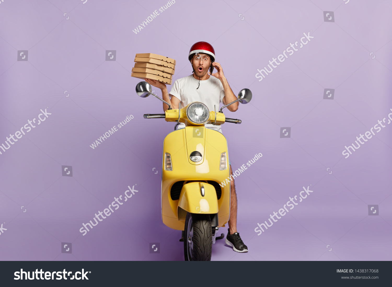 Food delivery concept. Shocked courier takes order over phone from customer, holds stack of cardboad pizza boxes, stops to have break drives fast motorbike, astonished to loose way, doesnt know route #1438317068