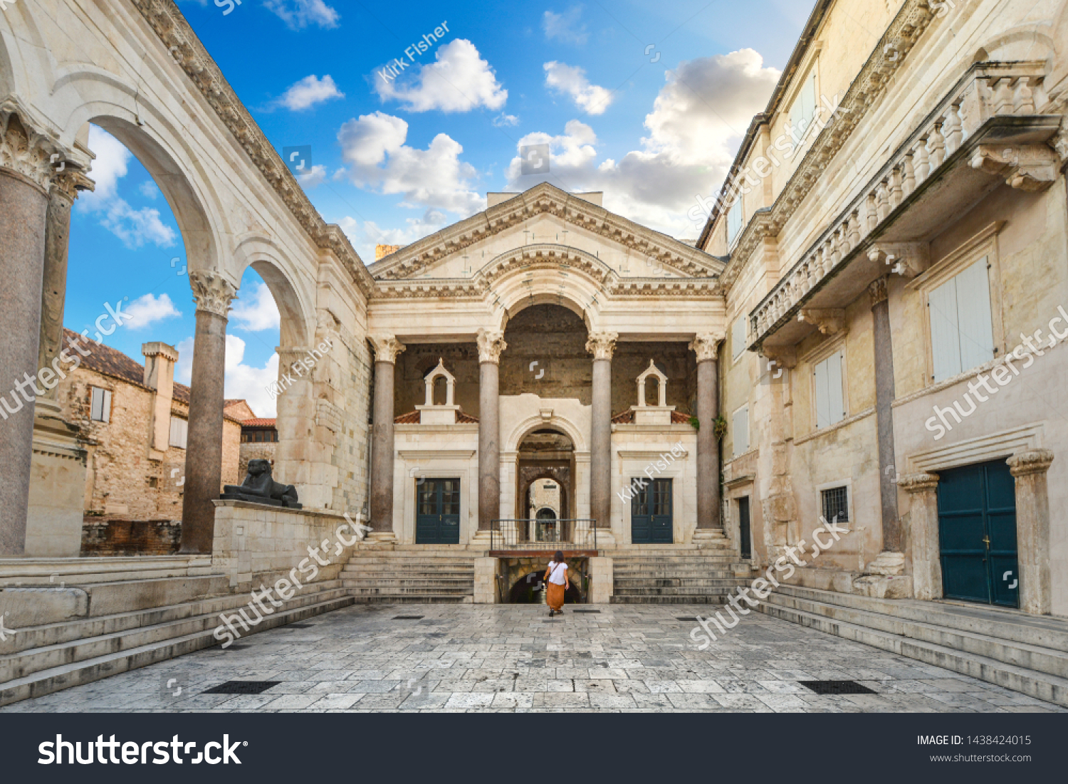 A woman walks through the Peristil or Peristyle Square of the ancient Diocletian's Palace in the old town area of Split, Croatia early in the morning. #1438424015
