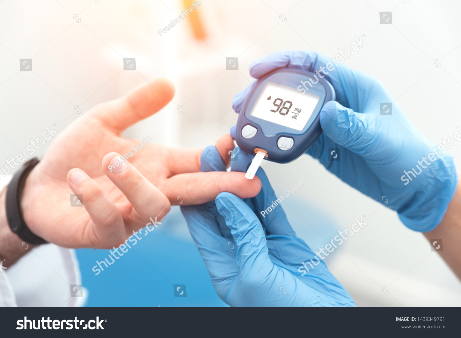 Doctor checking blood sugar level with glucometer. Treatment of diabetes concept. #1439349791