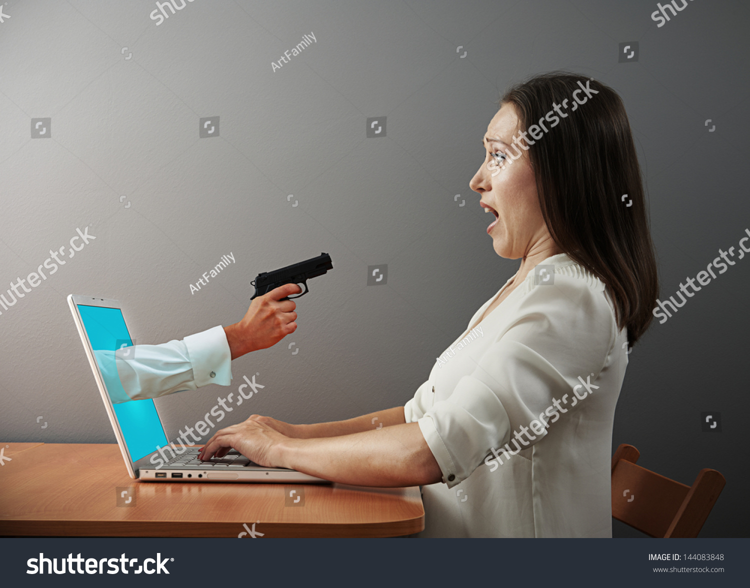 startled woman looking at hand with gun #144083848