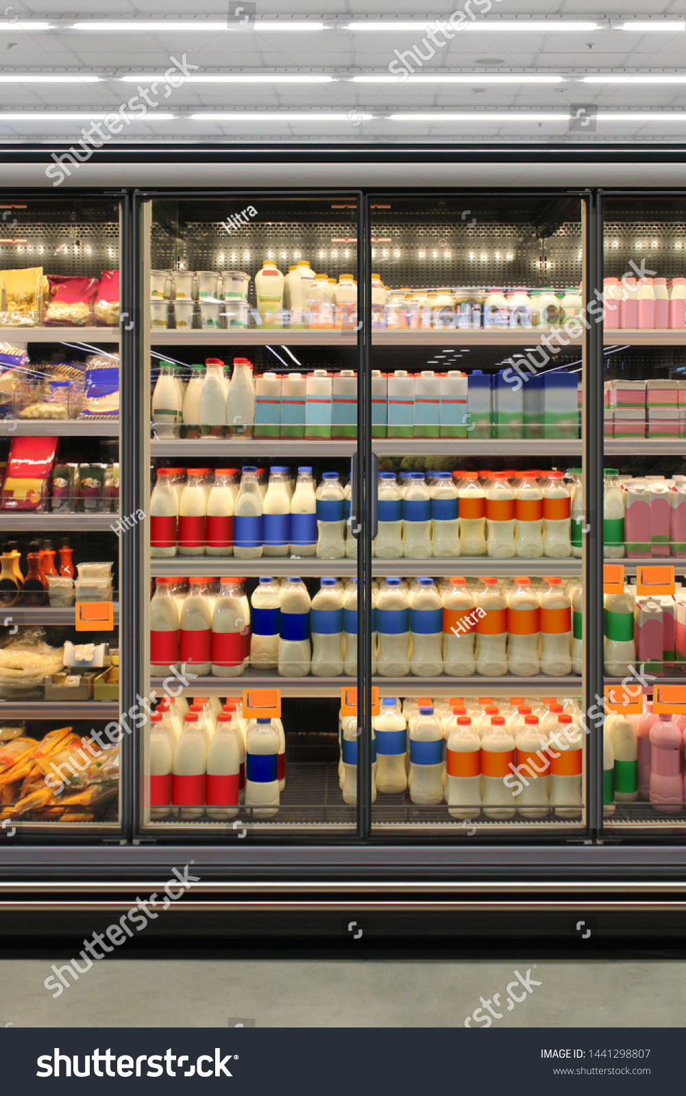Dairy product in Glass door fridge Horizontal photo mockup yogurt and milk and plastic diary bottles in vertical freezer at supermarket. Suitable for presenting new Dairy packaging or label design #1441298807