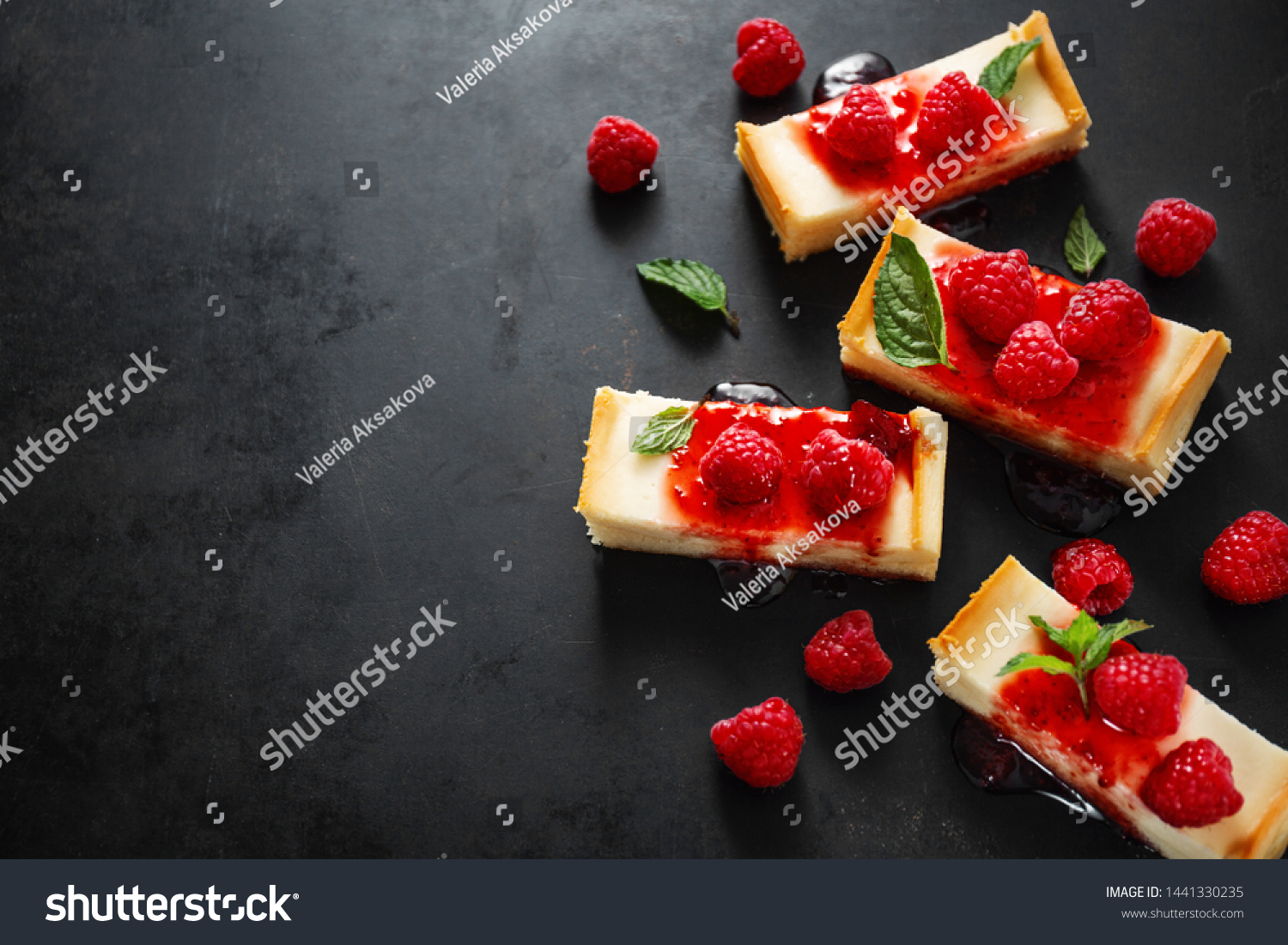 Sweet tasty background. Tasty cheese cake served with sauce, mint and raspberry on dark background. Copy space. Horizontal.  #1441330235