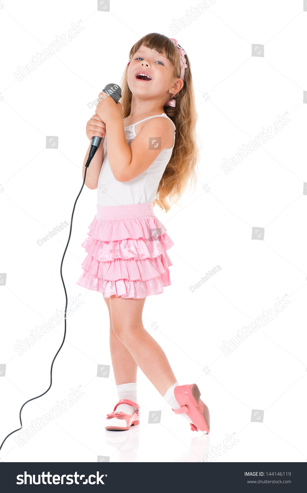 Beautiful little girl with microphone isolated on white background #144146119