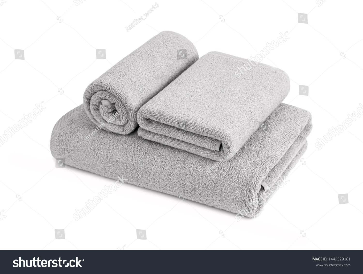 Gray terry towels rolled, folded and stacked isolated.Terry towels against white backdrop. Folded and rolled soft bath towels. Stack of grey cotton towels on a white background #1442329061