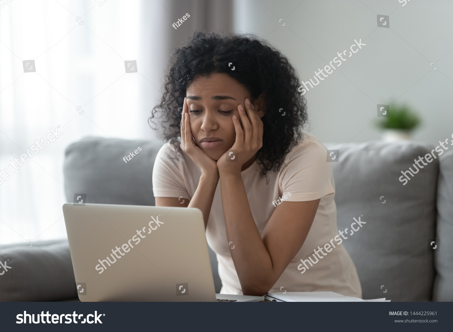 Bored young african american girl tired of learning sit at home looking at laptop, lazy apathetic black female university student frustrated about study computer work feeling uninterested demotivated #1444225961