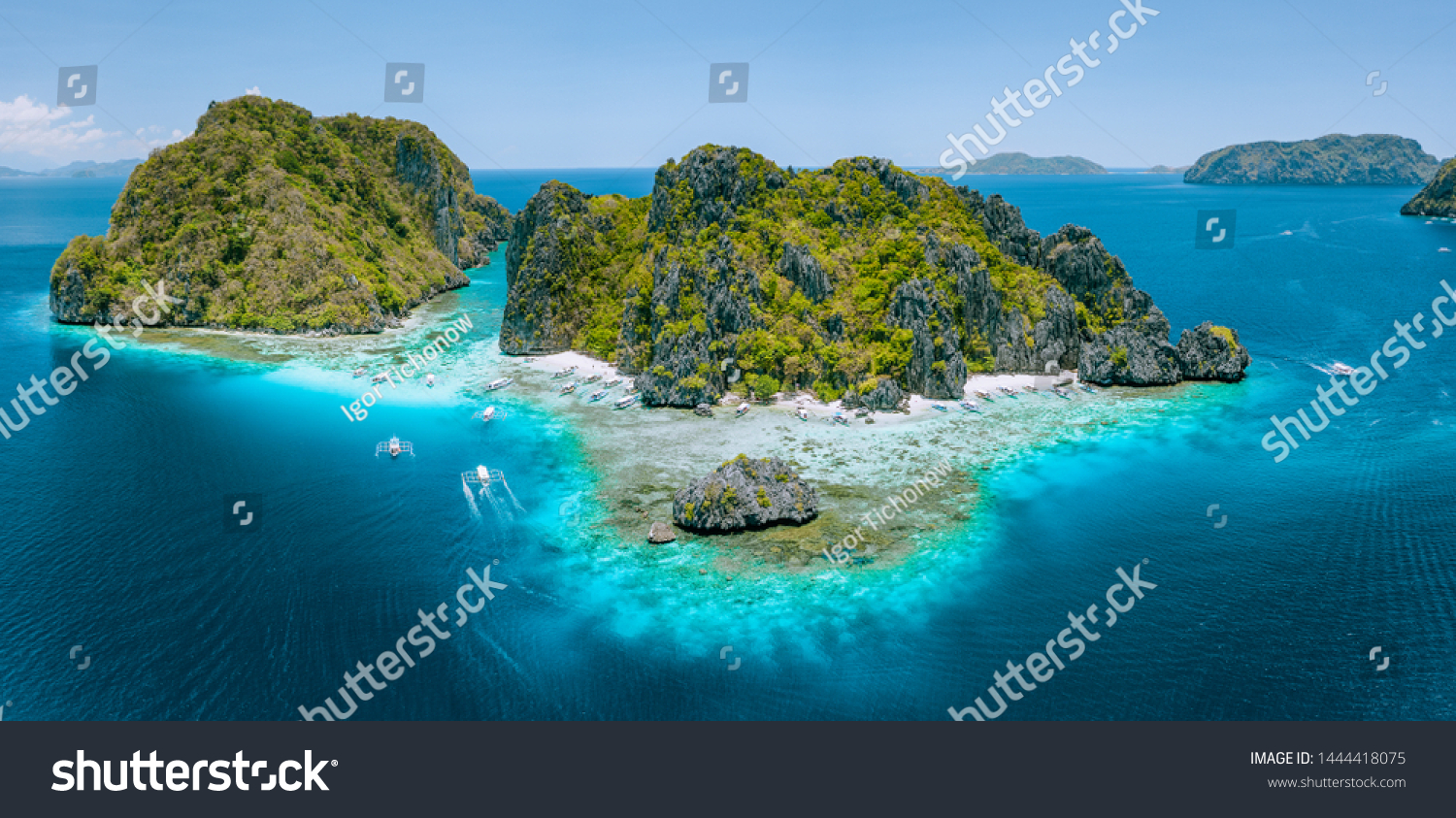Aerial drone view of tropical Shimizu Island steep rocks and white sand beach in blue water El Nido, Palawan, Philippines. Tourist attraction most beautiful famous nature spot Marine Reserve Park #1444418075