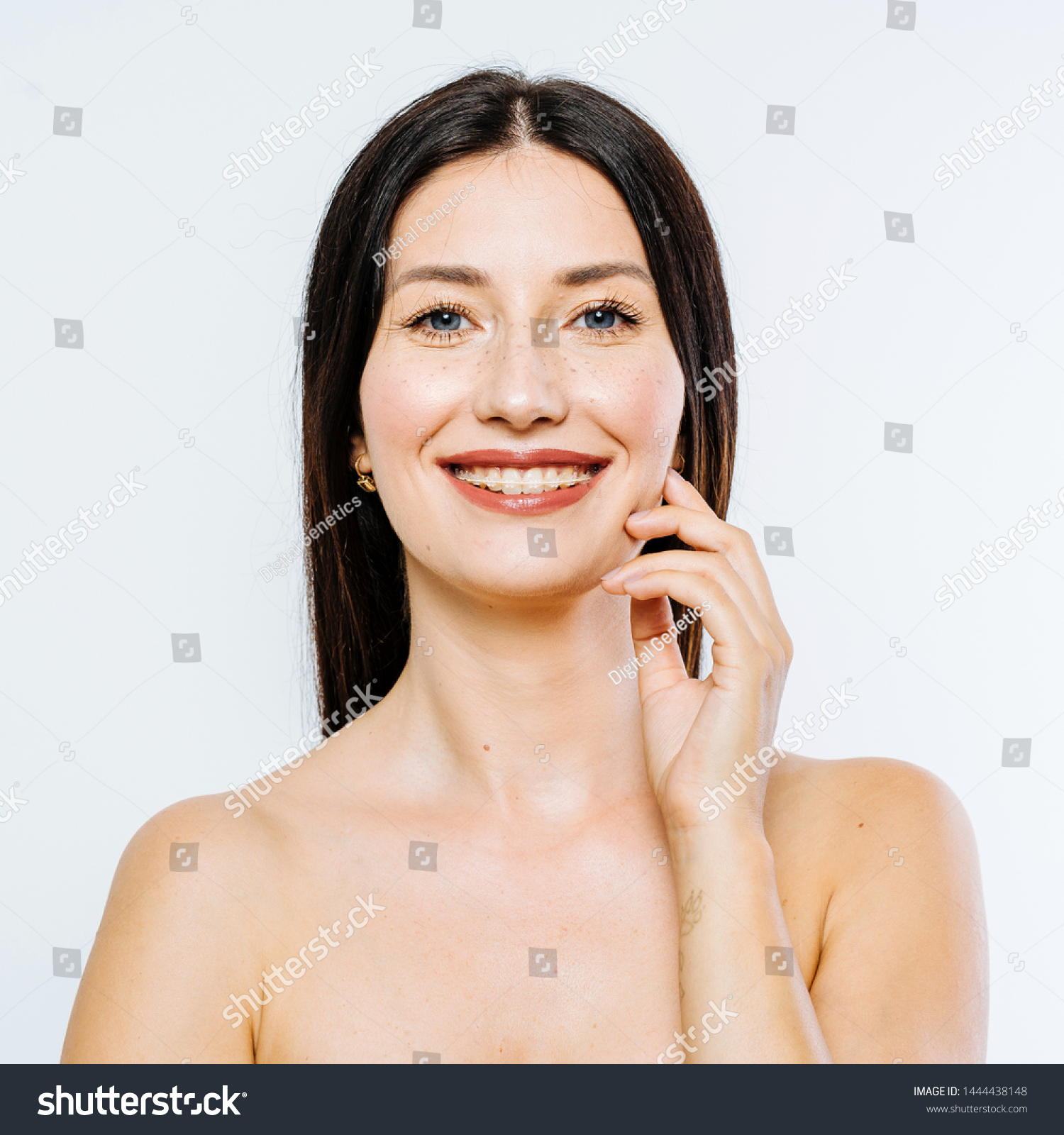 Portrait of beautiful brunette model with braces on white background #1444438148