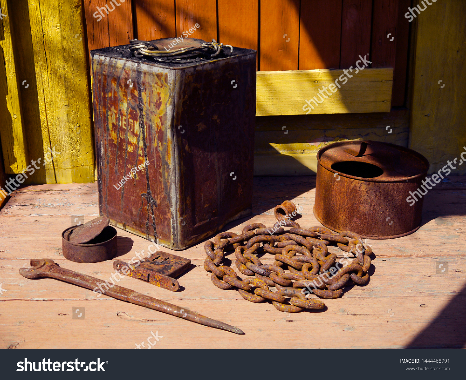 Old rustic gardening farm tools and utensils on the porch of a village house. The concept of agriculture, husbandry, horticulture and landscaping. #1444468991