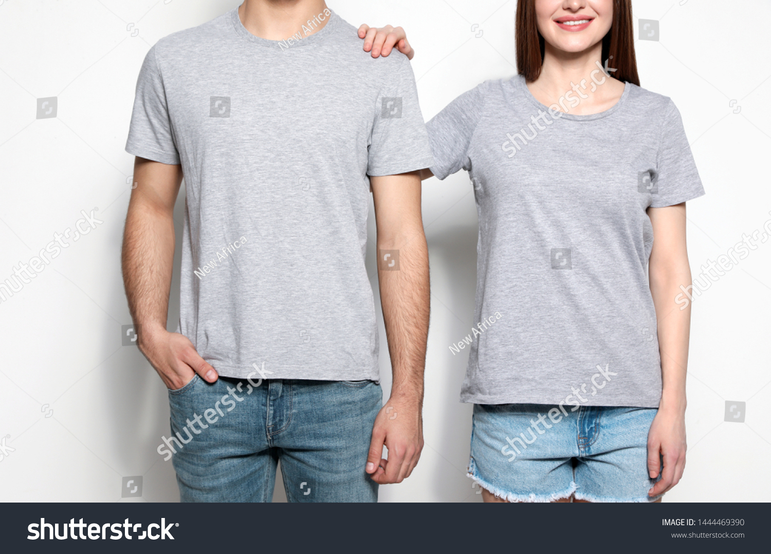 Young people in t-shirts on light background, closeup. Mock up for design #1444469390