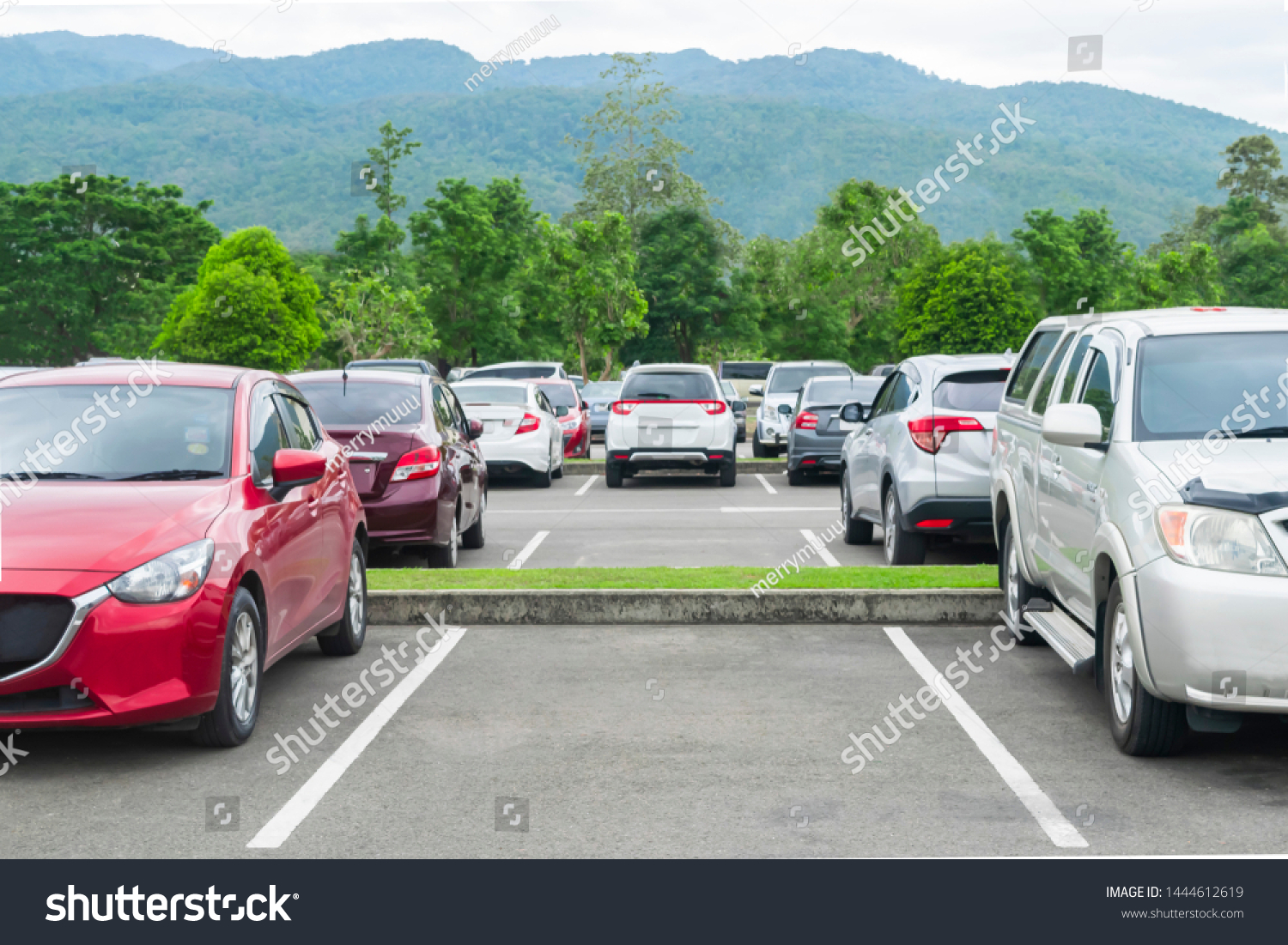 Car parked in asphalt parking lot and empty space parking  in nature with trees and mountain background .Outdoor parking lot with fresh ozone and eco friendly green environment concept
 #1444612619