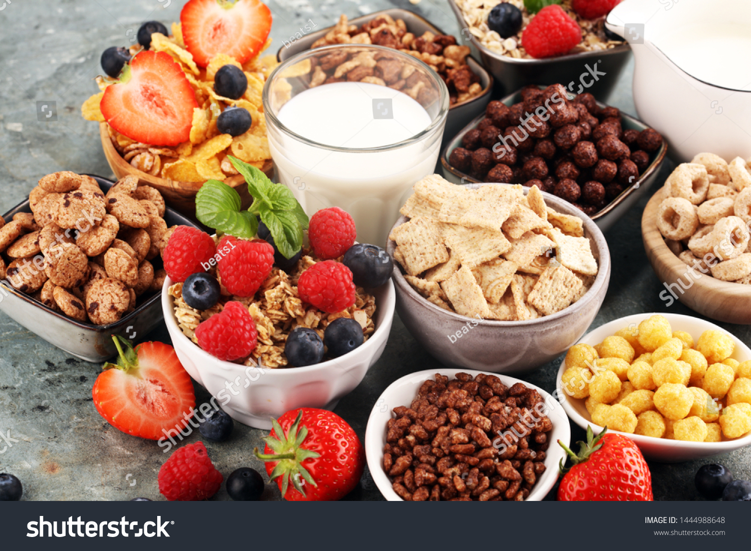 Cereal. Bowls of various cereals, fruits and milk for breakfast. Muesli with variety of kids cereals. #1444988648