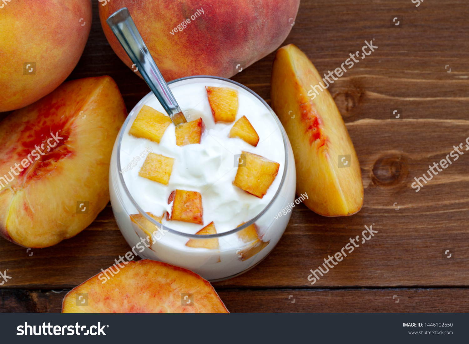 peach yogurt, sweet summer dessert. Curd dessert with fresh fruits. Eating healthy, vitamin-rich Breakfast. yogurt with slices of fresh peaches and whole peaches on a wooden background. close up. #1446102650