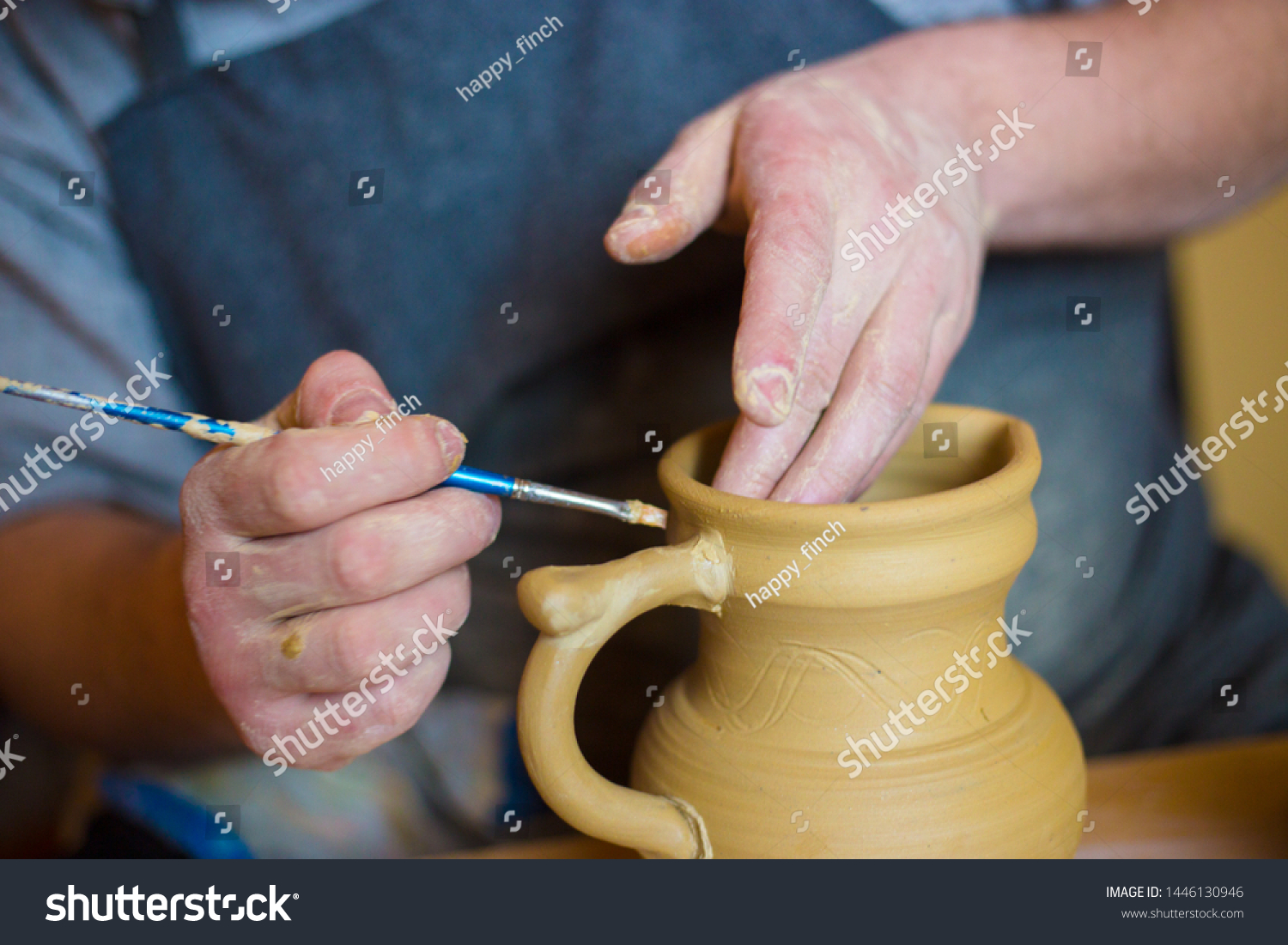 Professional male potter working in workshop, studio. Handmade, small business, crafting work concept #1446130946