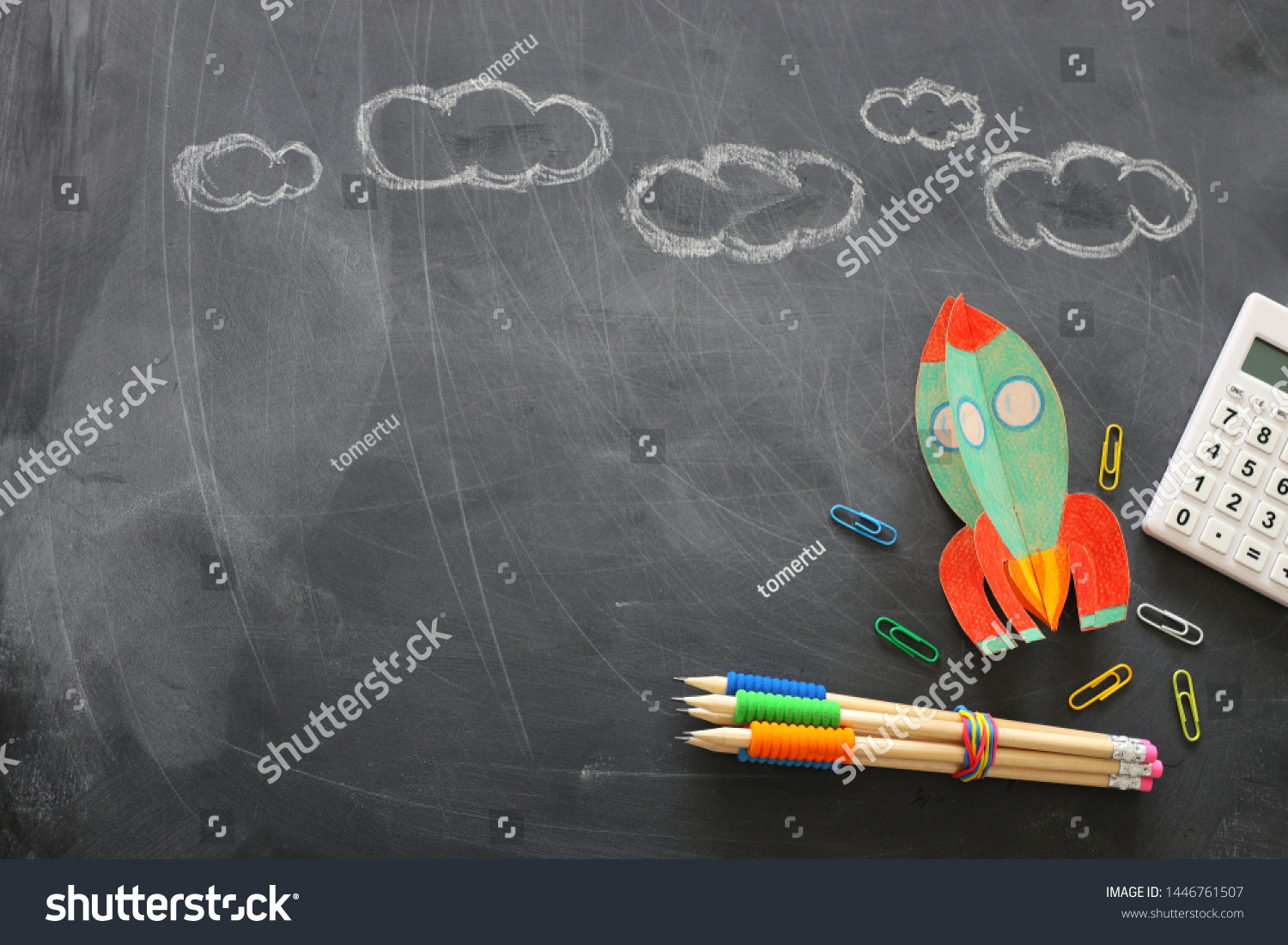 education. Back to school concept. rocket cut from paper and painted over blackboard background. top view, flat lay #1446761507