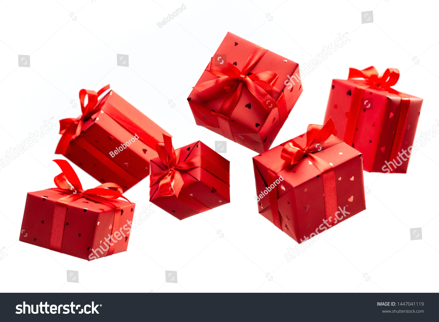 Surprise in flying boxes wrapped in red gift paper with bow on white background. Concept of holidays and greeting cards. Copy space.	 #1447041119