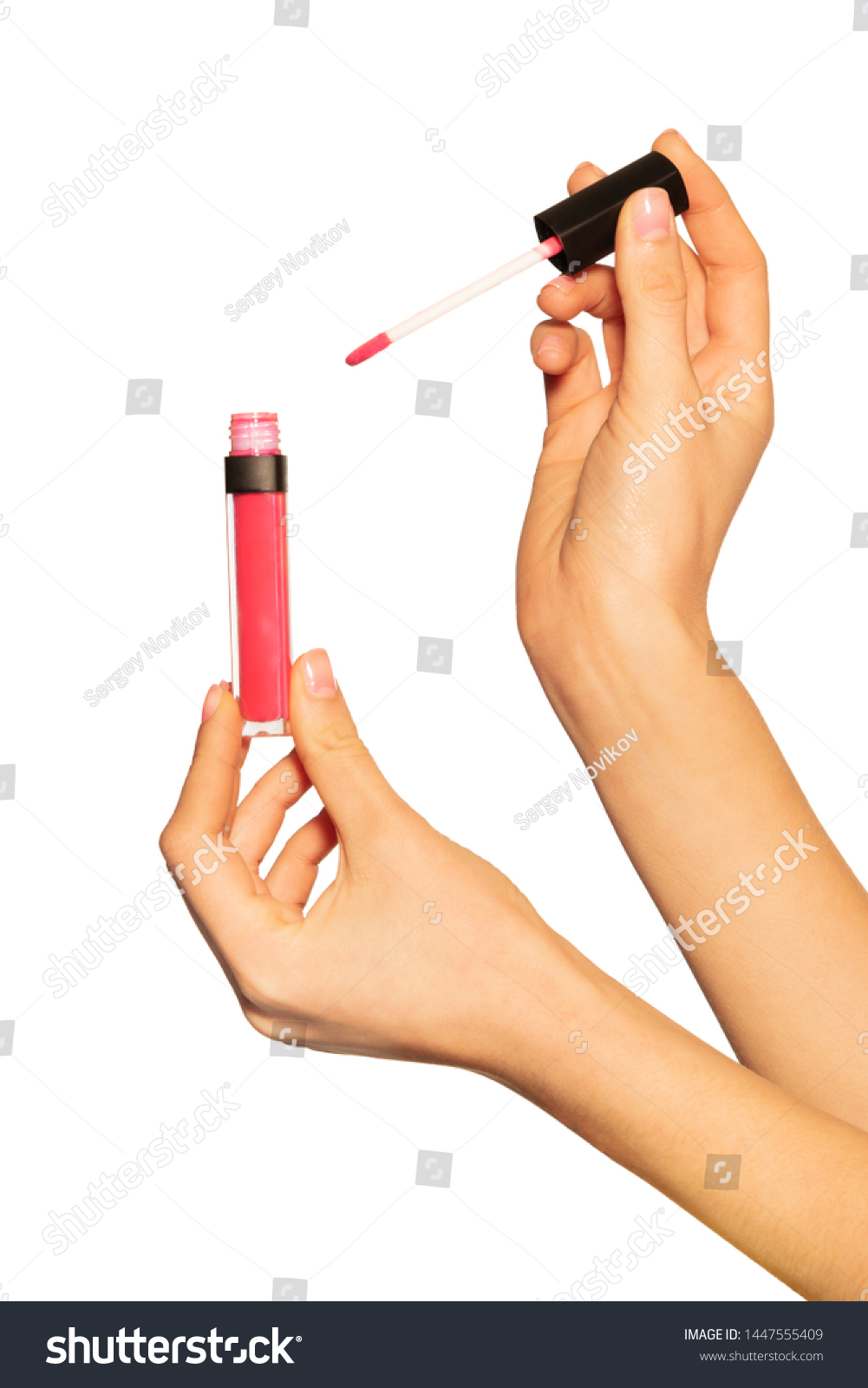 Female hands holding lip gloss tube and applicator #1447555409