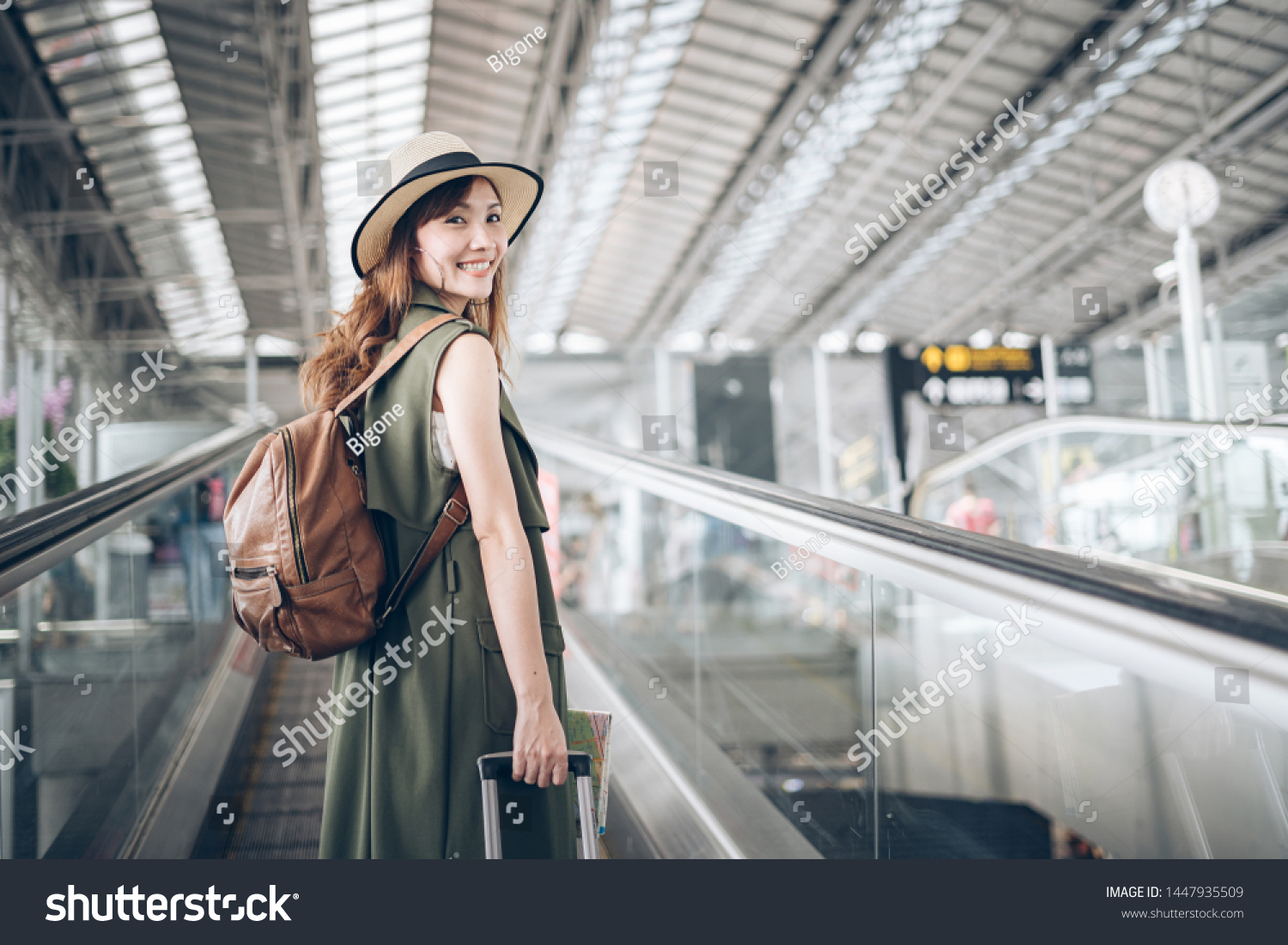 Journey at Airport Terminal  , Asian woman traveler walking dragging a suitcase to gate in airport #1447935509