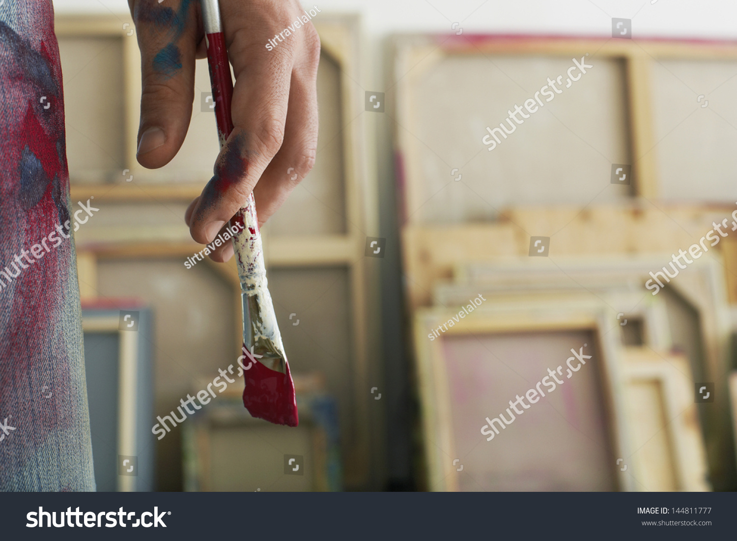 Closeup of an artist holding paintbrush #144811777