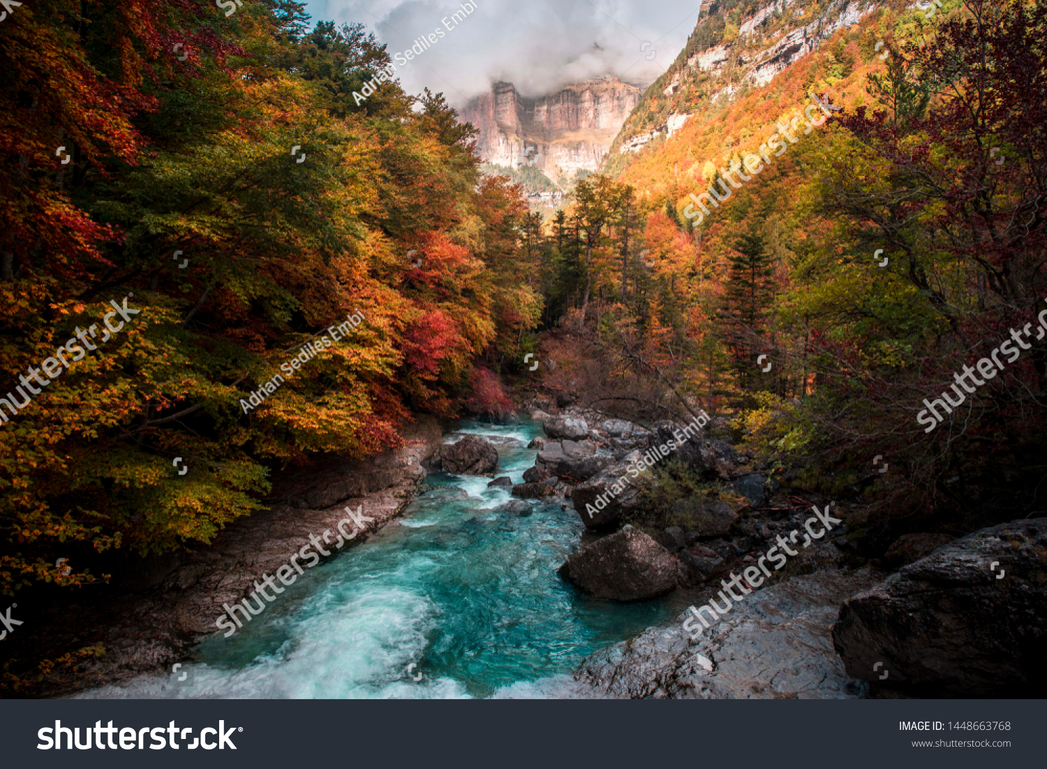 Photograph of the river Arazas on its way through the Ordesa valley, taken in autumn with those orange colors. #1448663768