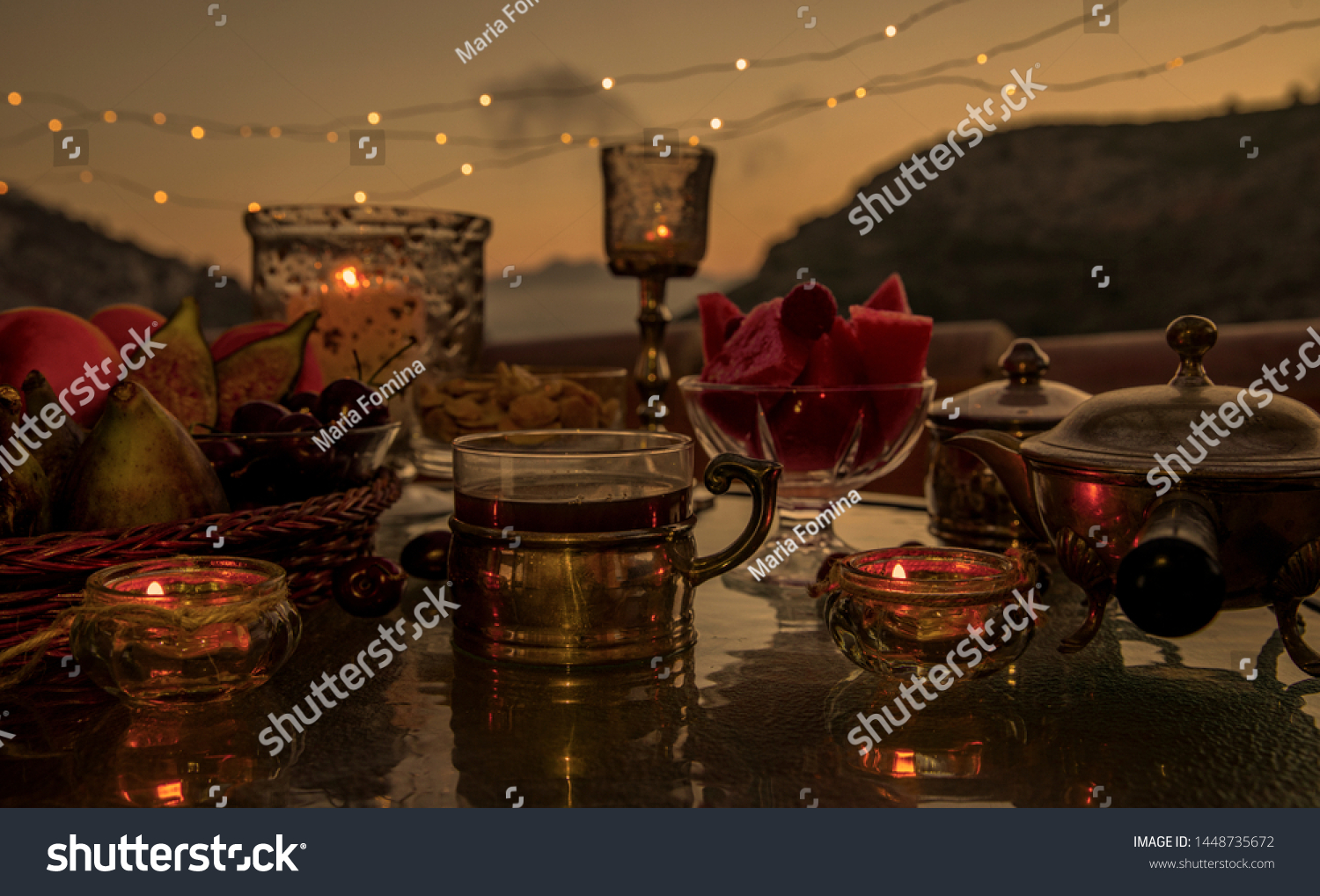 Evening tea. Evening tea with sweets. Very cozy vintage style still life on the background of a garland of light bulbs and the night sky. #1448735672