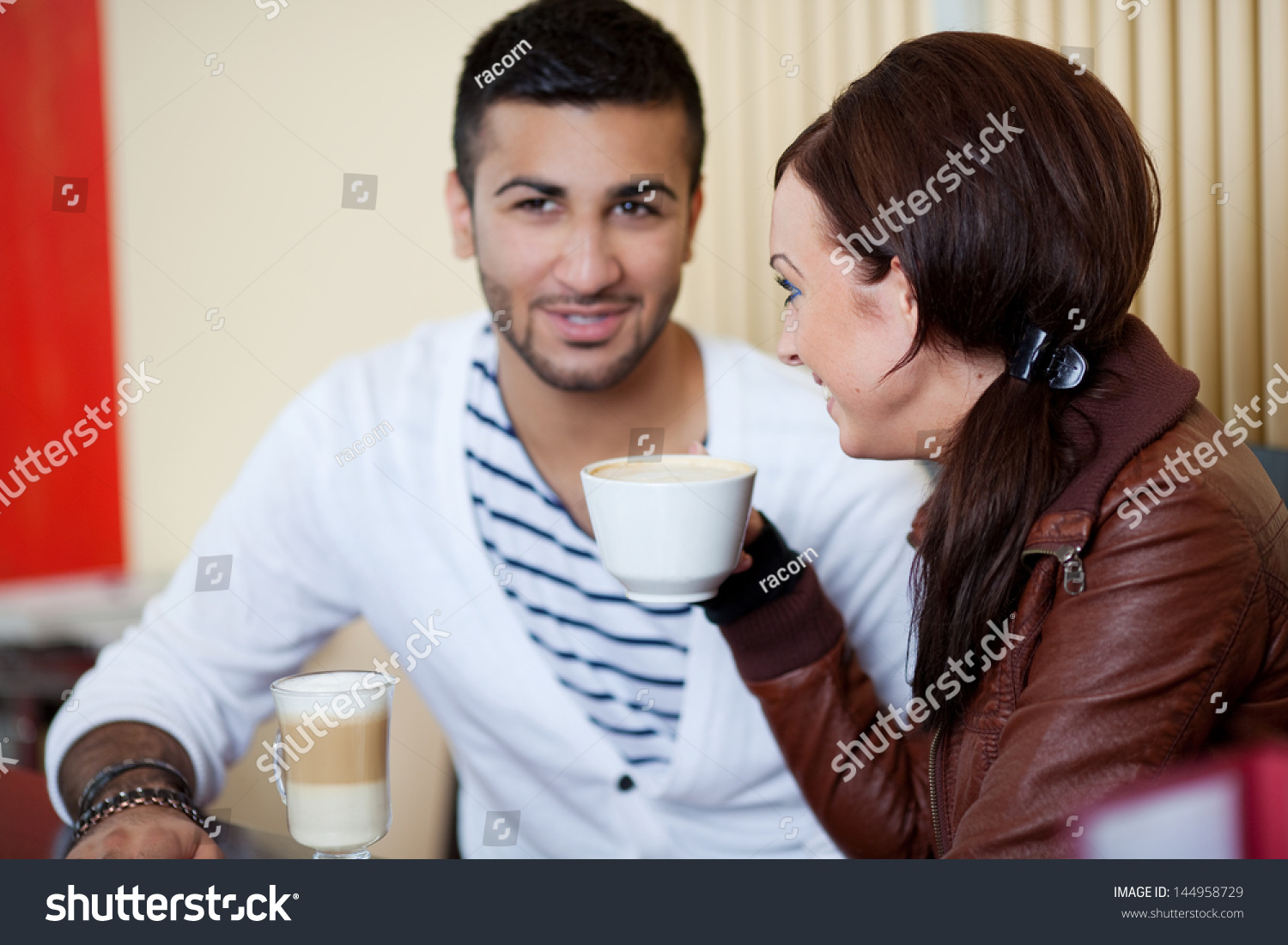 beautiful young couple talking in a cafe #144958729