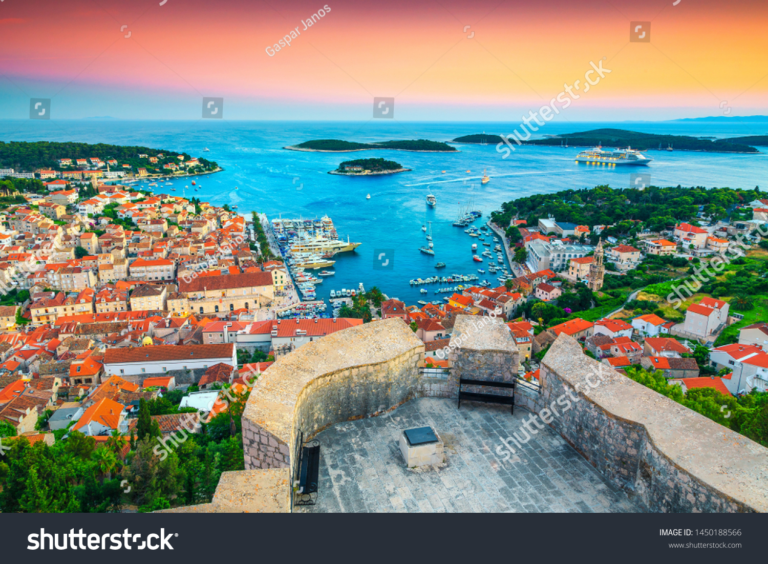 Famous touristic and travel destination. View from the Tvrdava Fortica (Spanjola) fortress at sunset. Green islands, blue lagoons and fantastic harbor, Hvar, Hvar island, Dalmatia, Croatia, Europe #1450188566