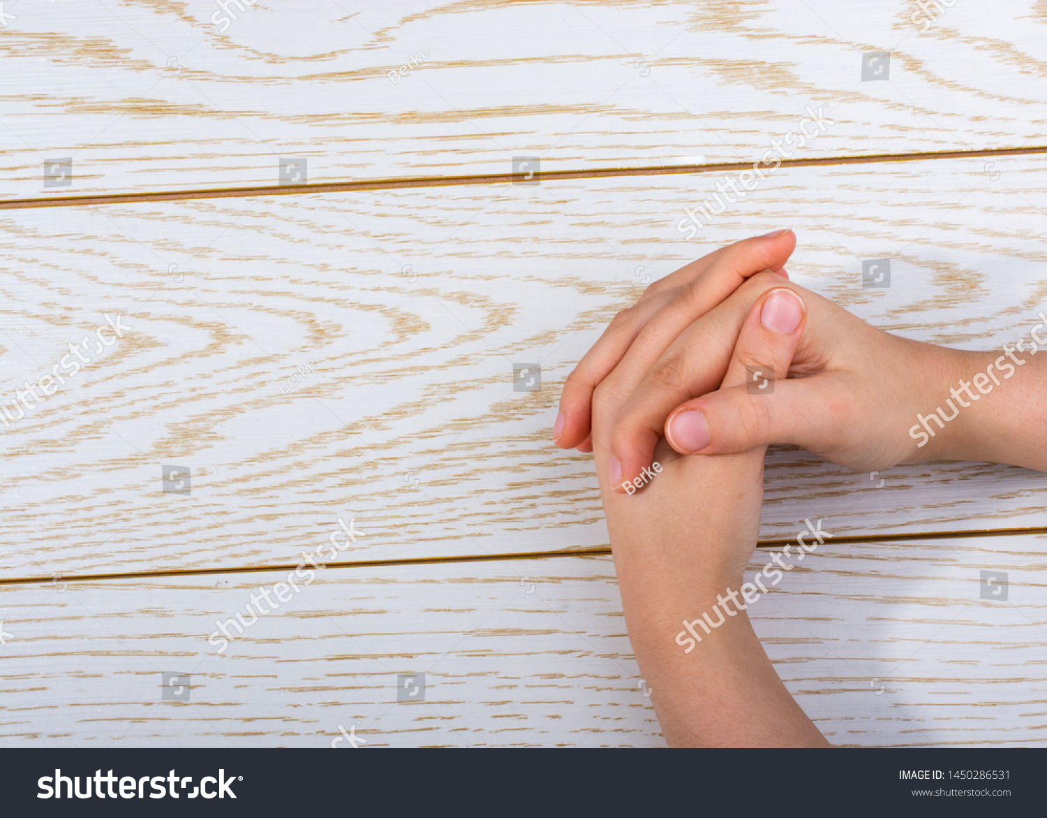 Hands making a gesture on a wooden background #1450286531