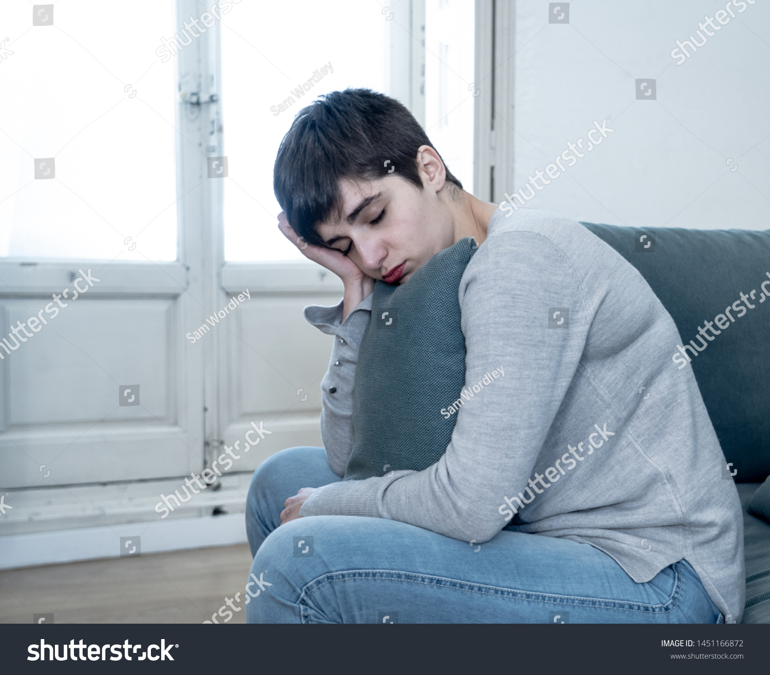 Beautiful desperate and depressed young woman on sofa feeling sad, hopeless and in pain suffering from Depression in People, Mental health,broken heart, Grief and Psychology concept. #1451166872