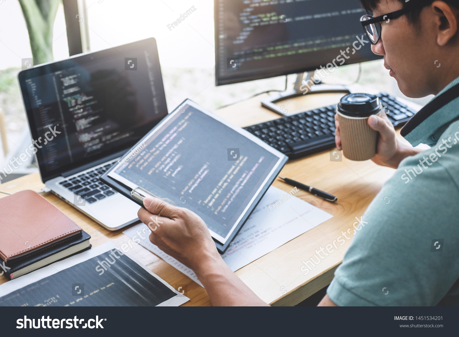 Young Professional programmer working at developing programming and website working in a software develop company office, writing codes and typing data code, Programming with HTML, PHP and javascript. #1451534201