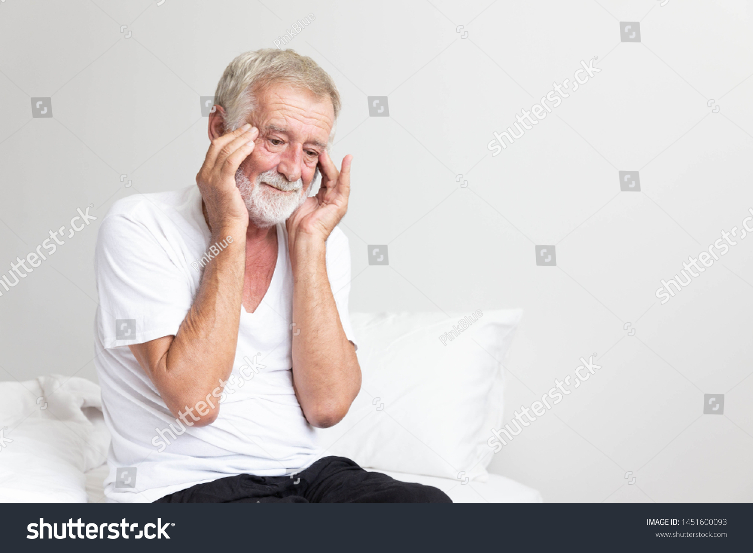 Portrait of a senior retirement man sitting and thinking alone on bed in his home #1451600093