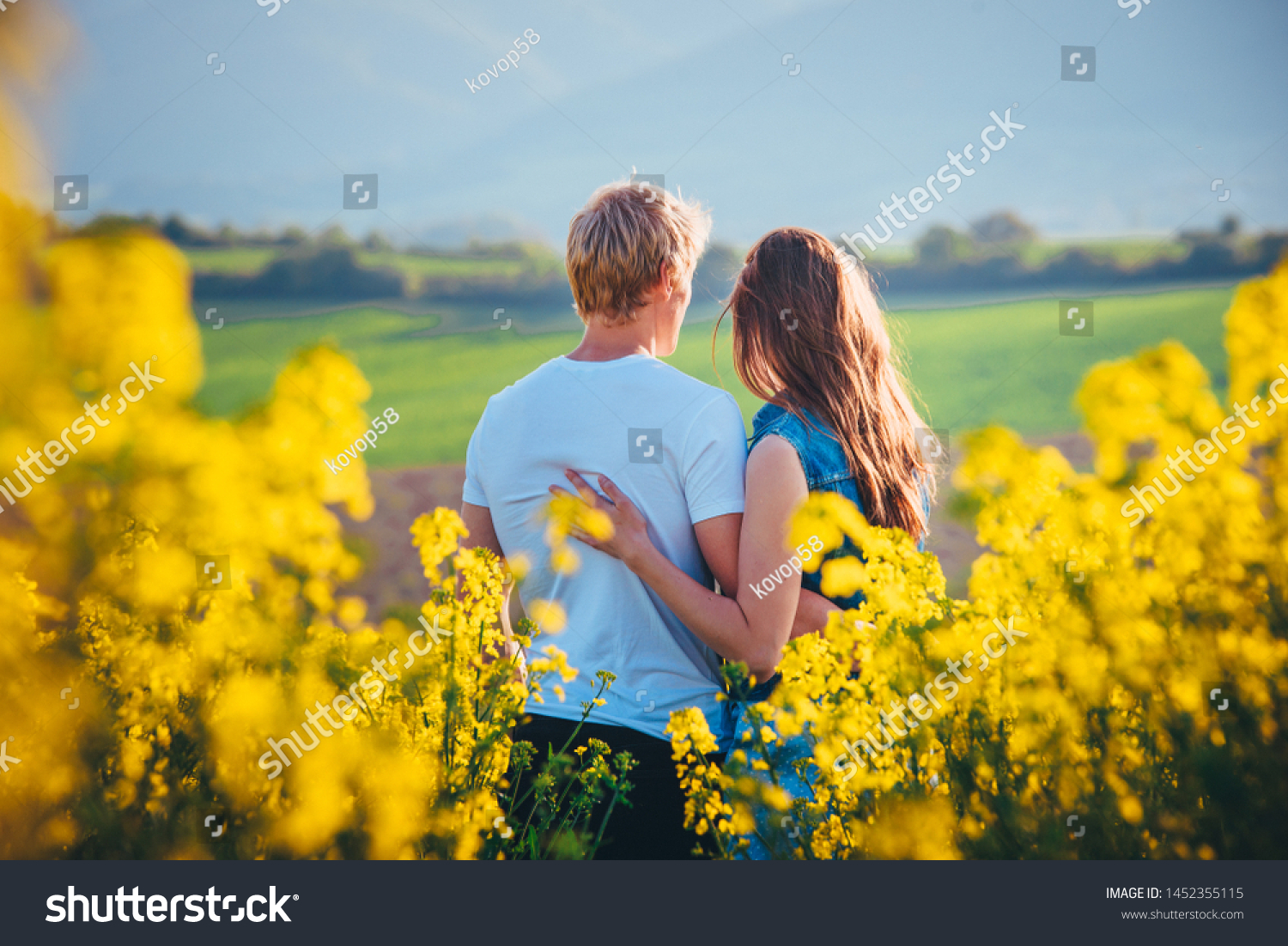 Couple hugging at sunset in yellow spring field. Romantic photo, white edit space #1452355115