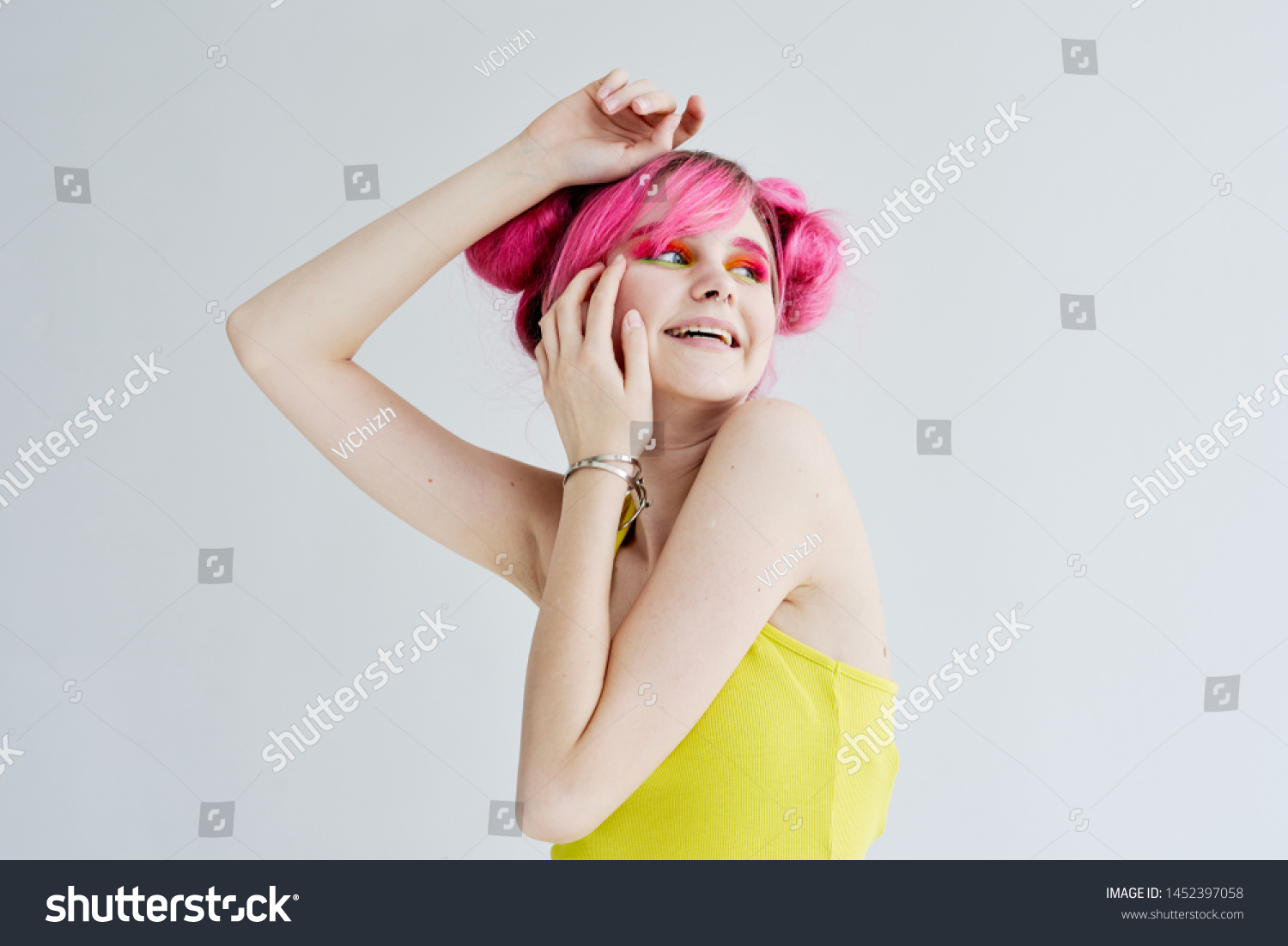 woman in a yellow shirt with pink hair #1452397058