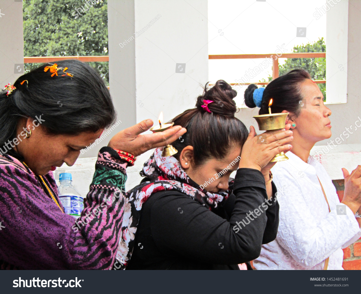 Chandragiri, Nepal - April 11 2018; Three women holding a candle for a religious ritual in Chandragiri, Nepal on April 11 2018 #1452481691