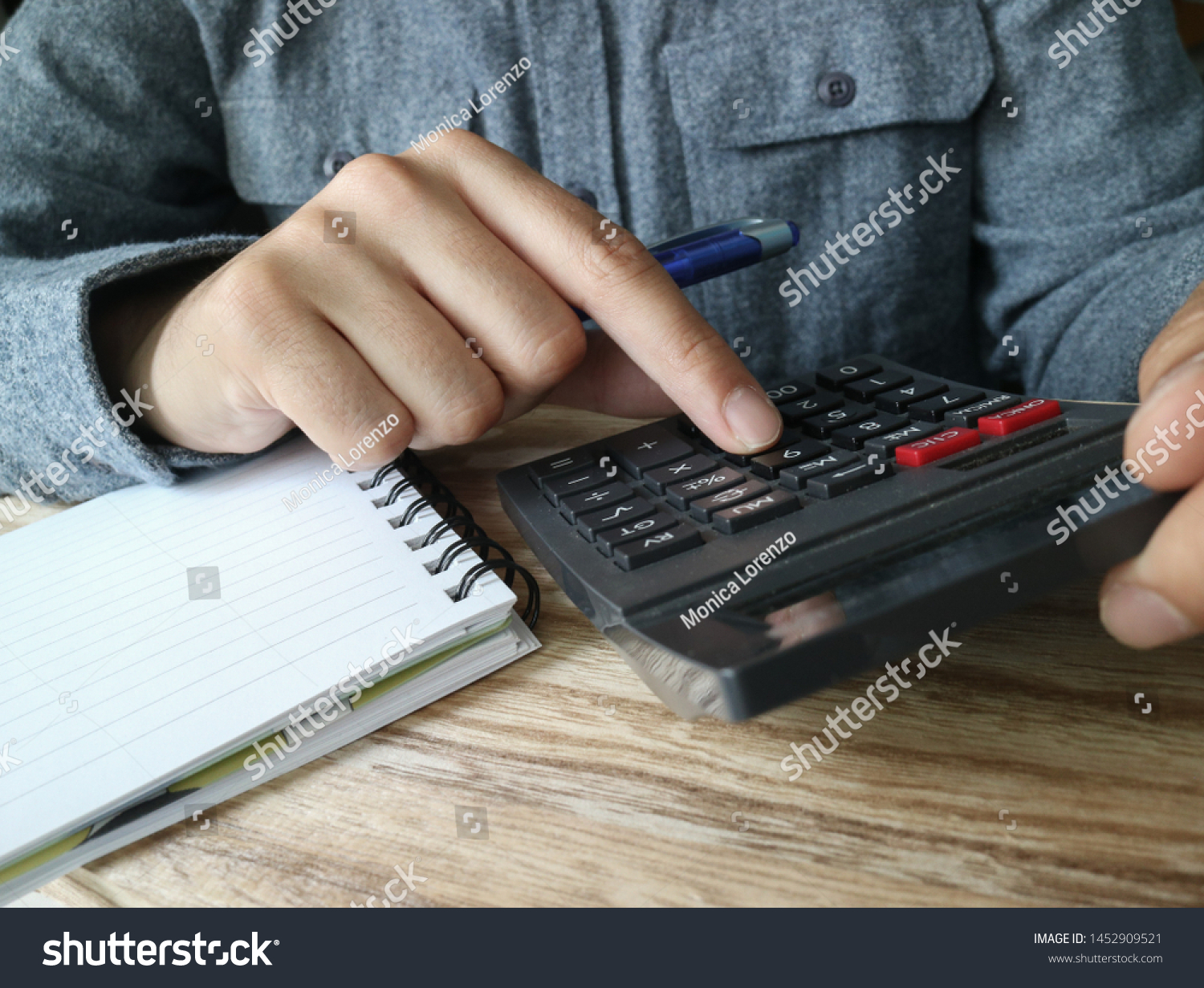 Finger clicking a number on a calculator  #1452909521