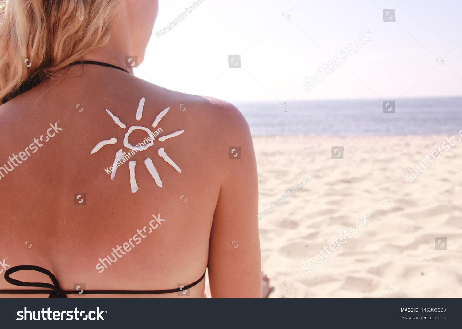of sun cream on the female back on the beach #145309000