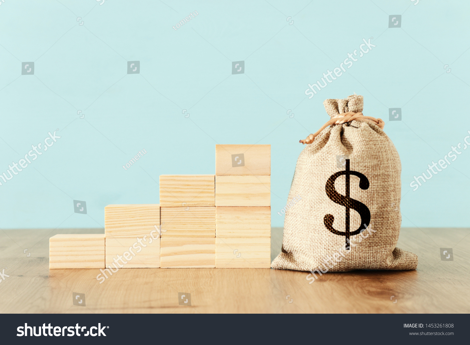 business image of a sack with money over wooden desk #1453261808