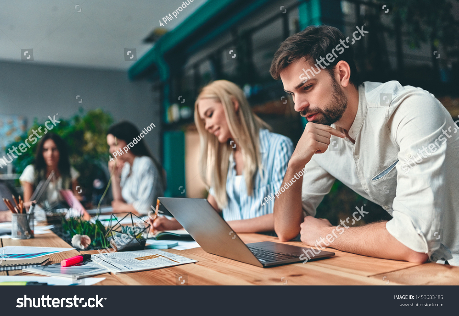 Group of young business people are working together in modern office. Creative people with laptop, tablet, smart phone, notebook. Successful hipster team in coworking. Freelancers. #1453683485