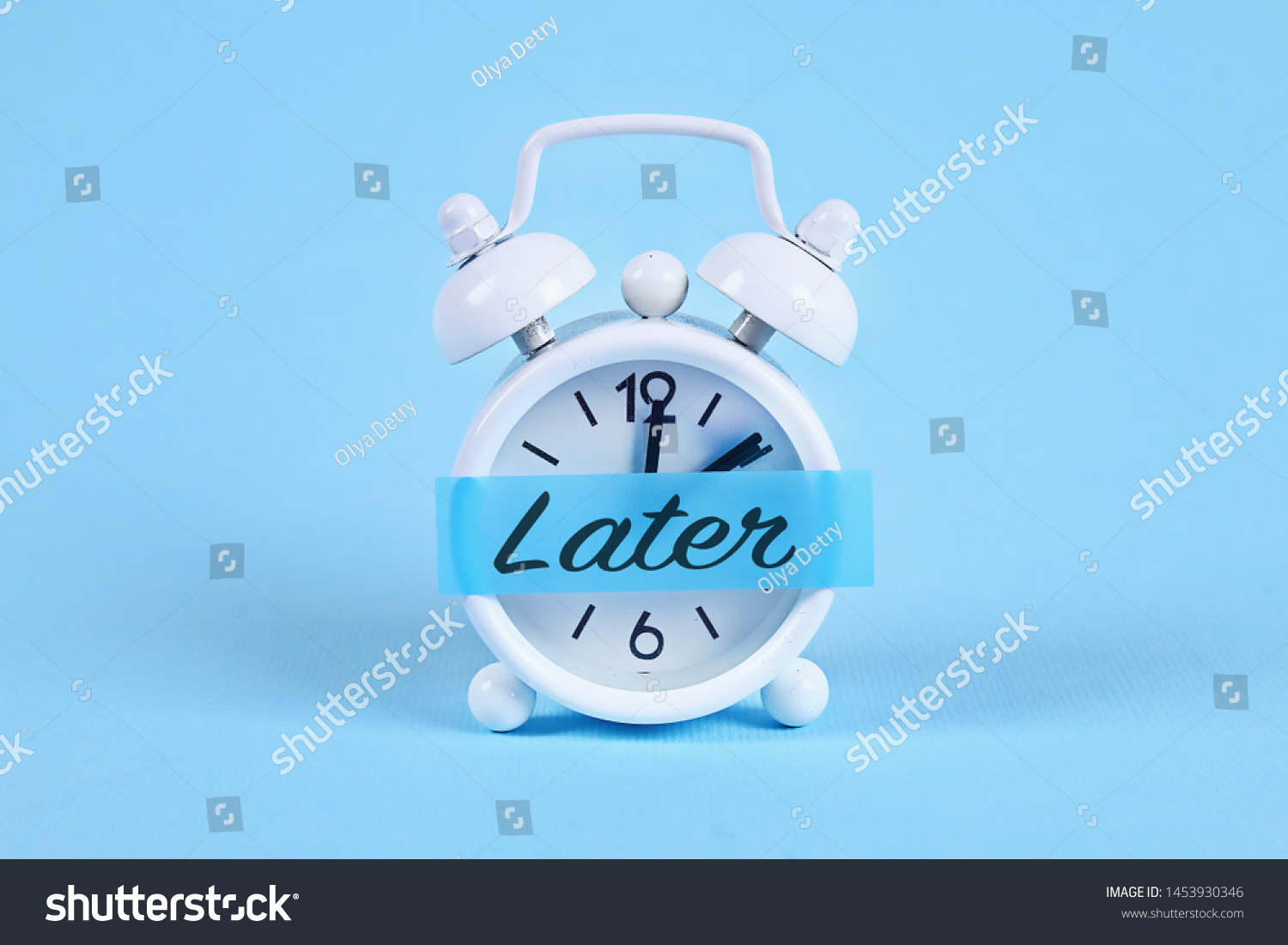 Procrastination, delay and urgency concept. White alarm clock with a sticky note with text later. #1453930346