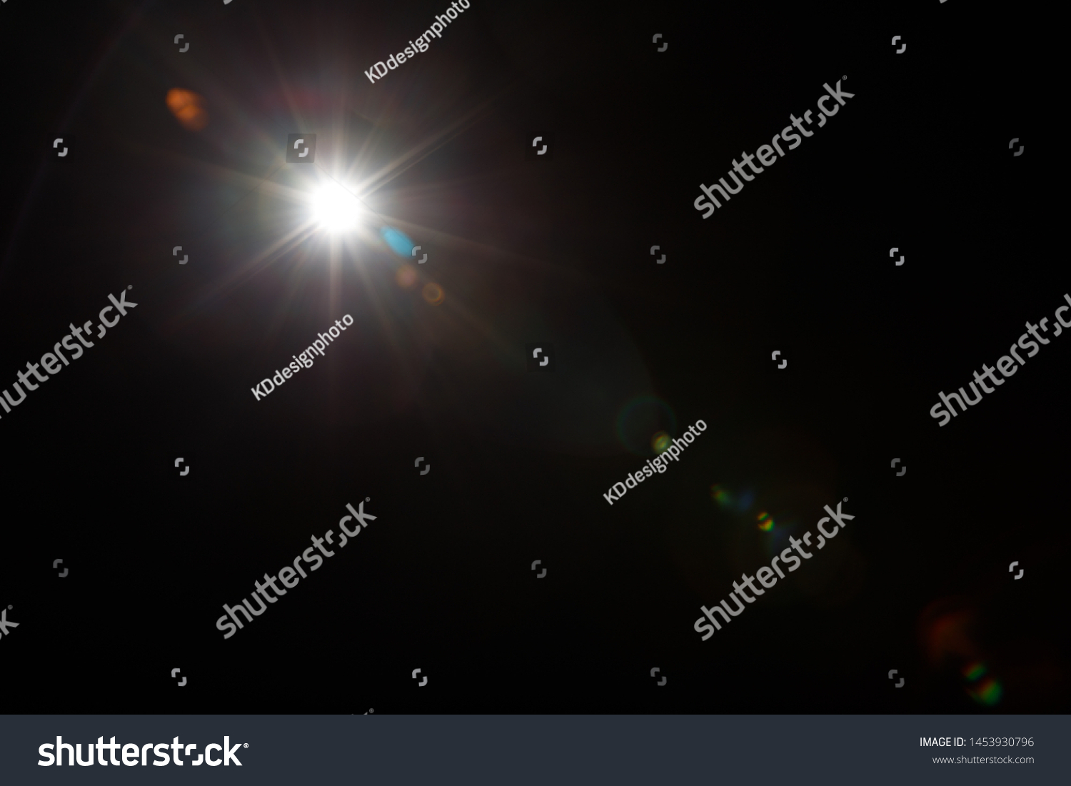 Lens Flare. Light over black background. Easy to add overlay or screen filter over photos. Abstract sun burst with digital lens flare background. Gleams rounded and hexagonal shapes, rainbow halo. #1453930796