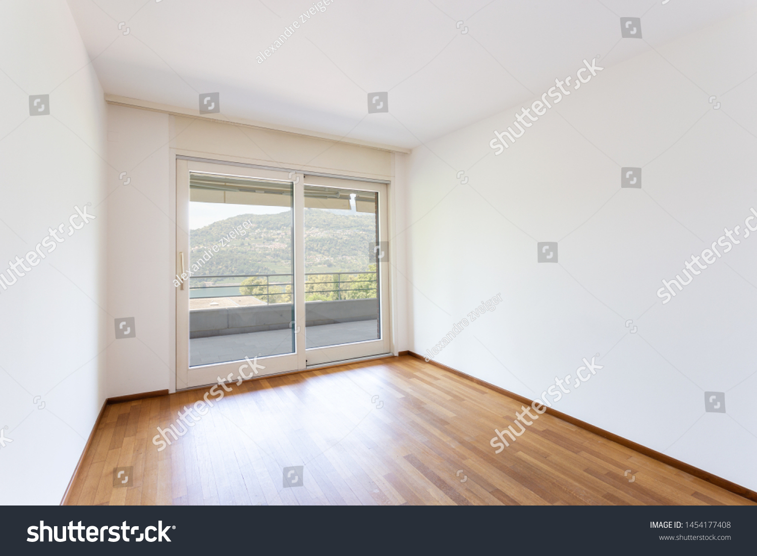 Bedroom with white walls and parquet. Window with lake view. Nobody inside #1454177408
