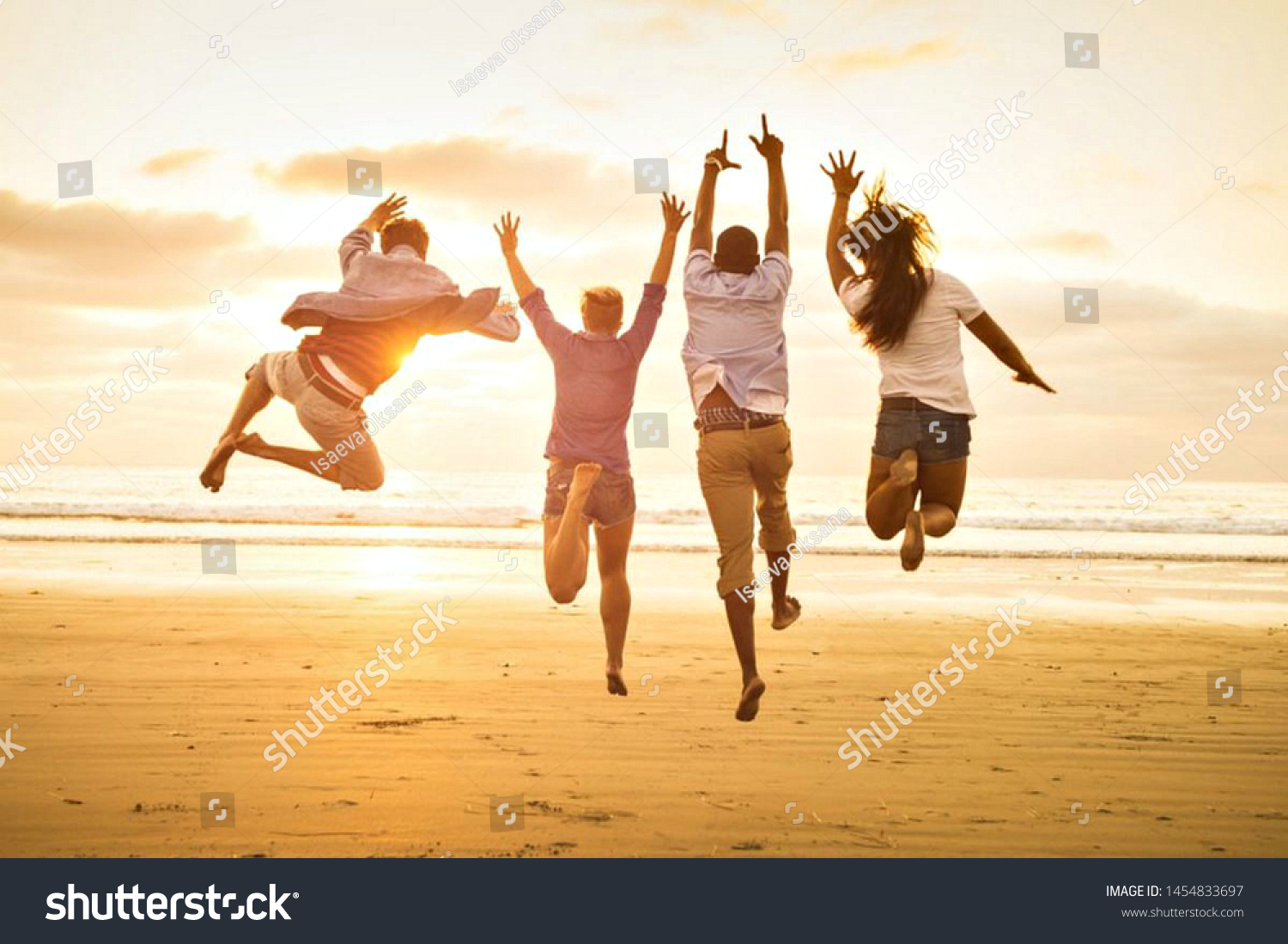 group of happy young people dancing on the beach #1454833697