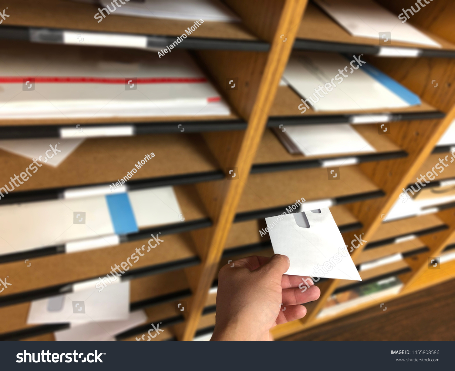 Man´s Hand Delivering & Receiving Mail from a Mailbox Sorter inside the Office. #1455808586