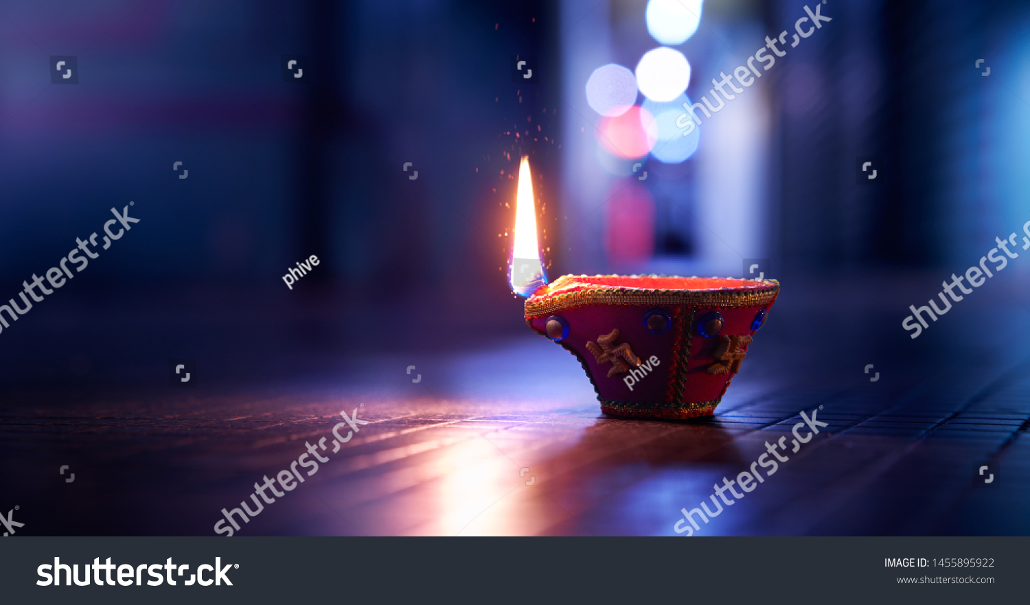 Happy Diwali - Lit diya lamp on street at night #1455895922