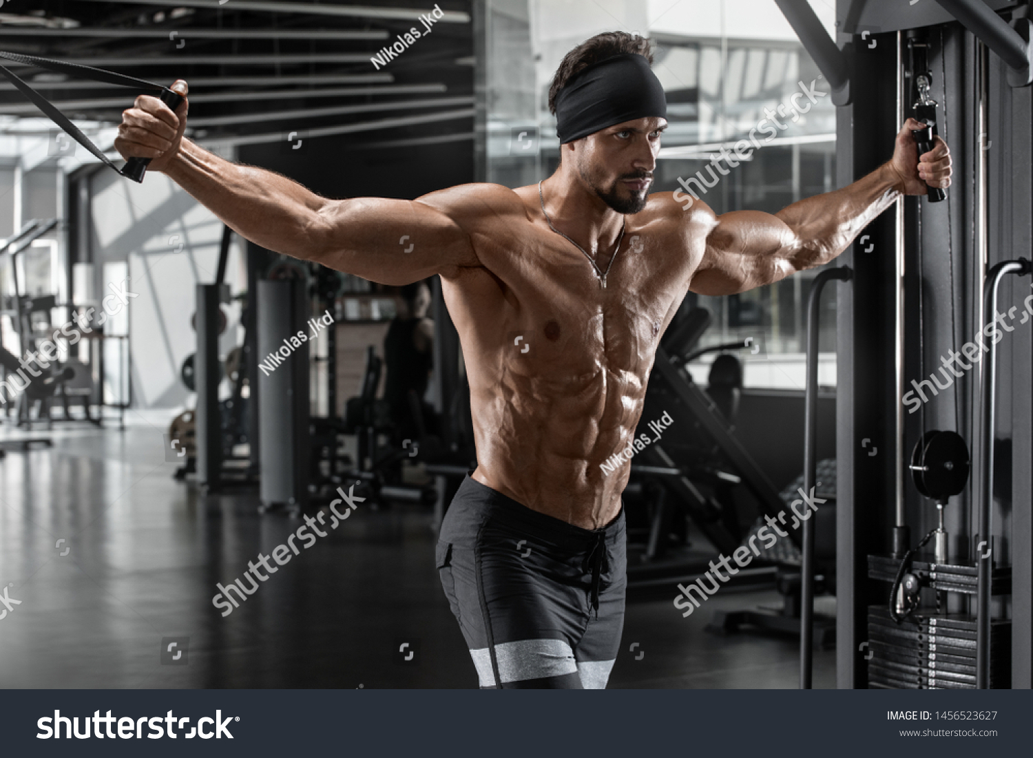 Muscular man workout in gym.  #1456523627
