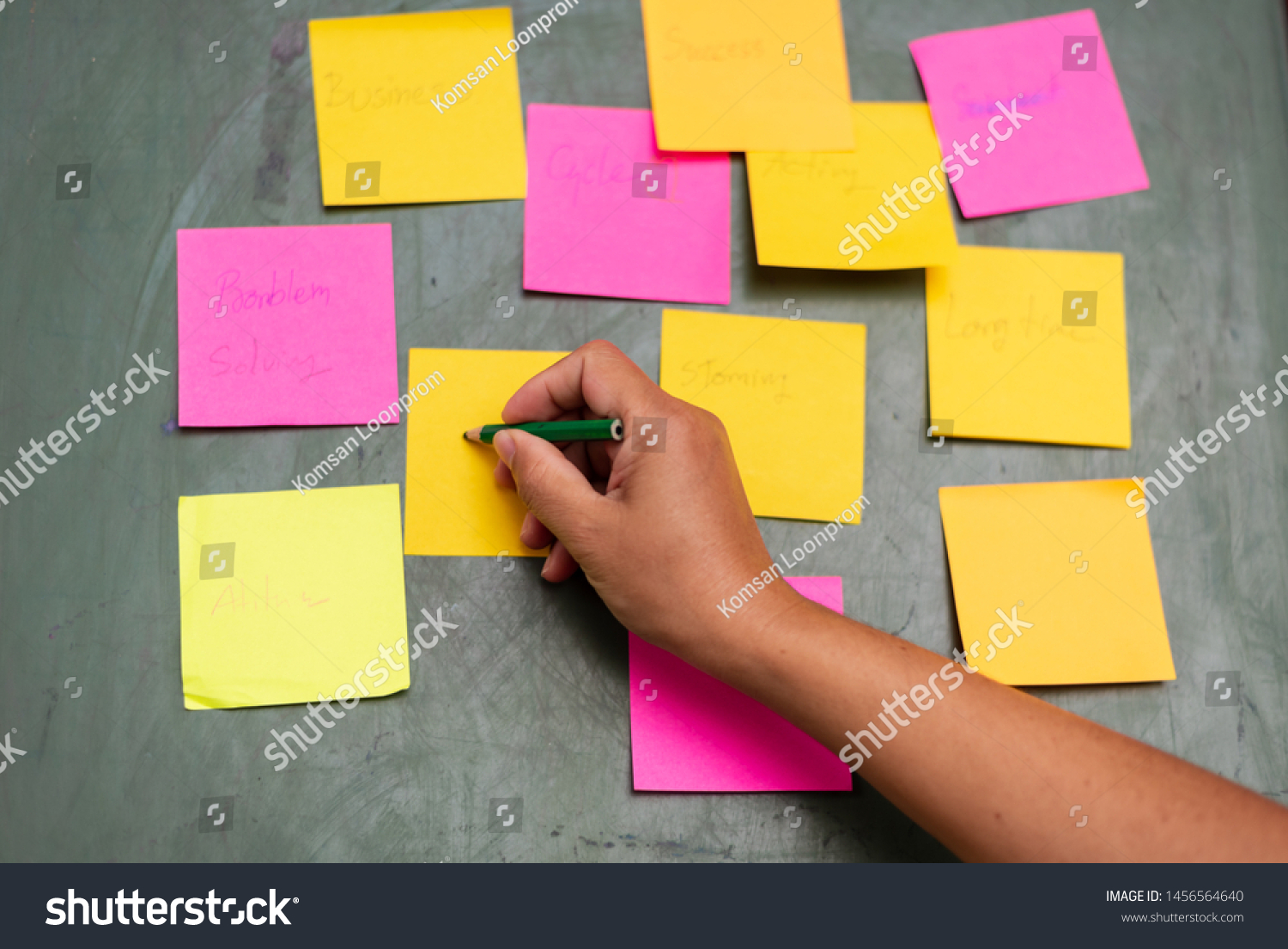 Close up woman hand writing colorful note sticky for brainstorm and share idea strategy workshop business.Brainstorming concept. #1456564640