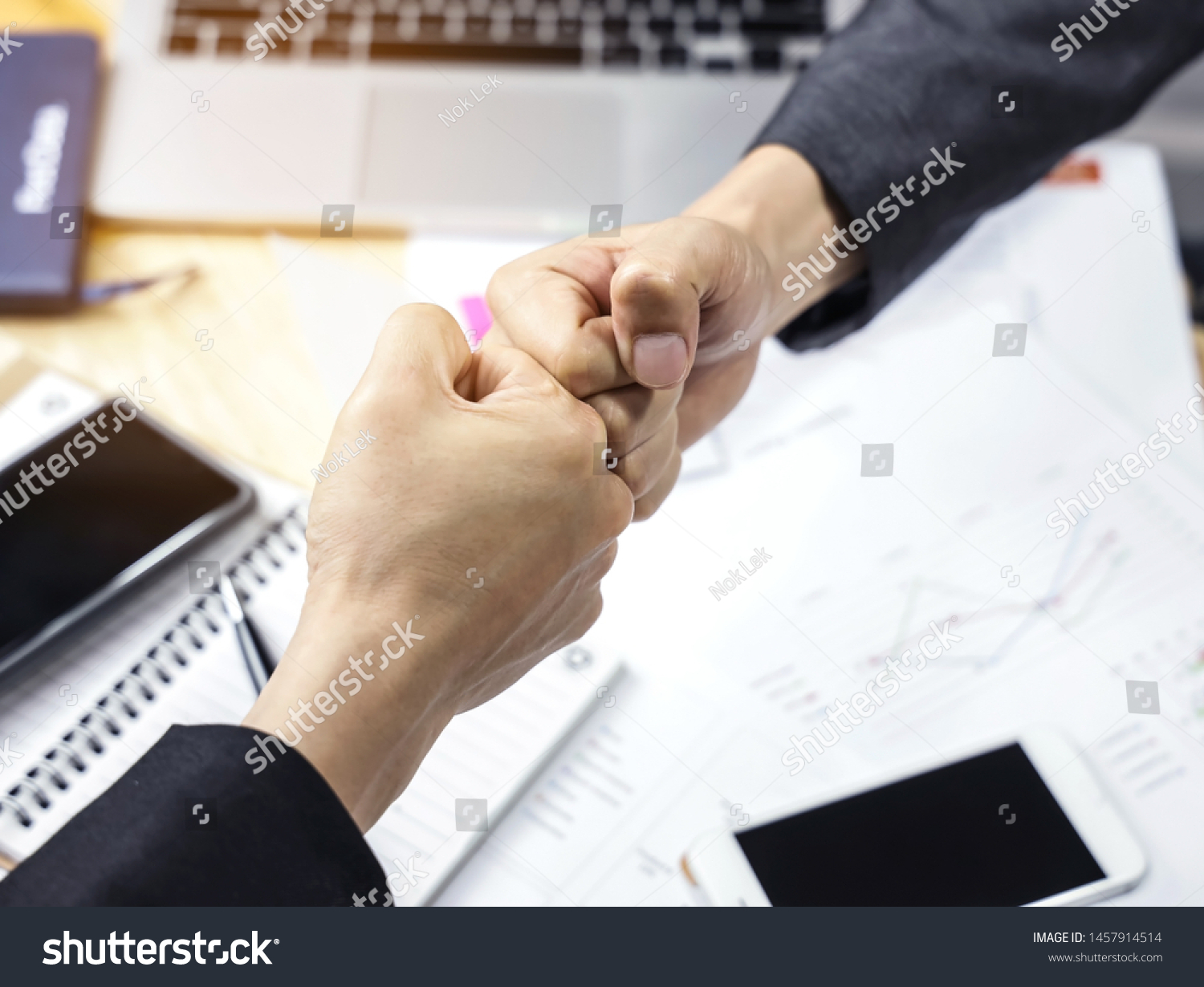 Businessman of a fist bump,which Businessmen trust commitment as support which Business Partners holding hands relationship marketing for reach successful achievement and meeting commit concept #1457914514