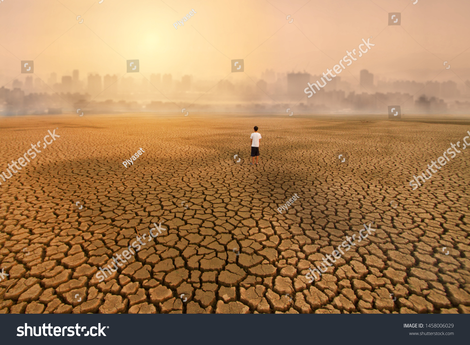 a man standing at empty land of dry cracked earth and looking to the big city with air polluted environment metaphor Climate change, Water crisis, Environment pollution of activity from urban concept. #1458006029