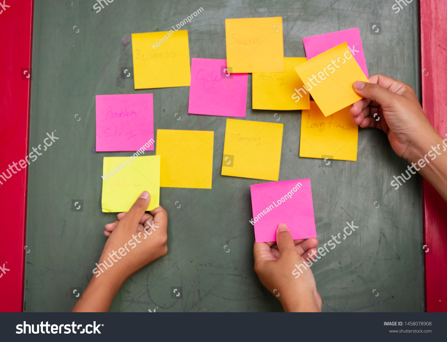 Close up woman hand holding colorful note sticky for brainstorm and share idea strategy workshop business.Brainstorming concept. #1458078908