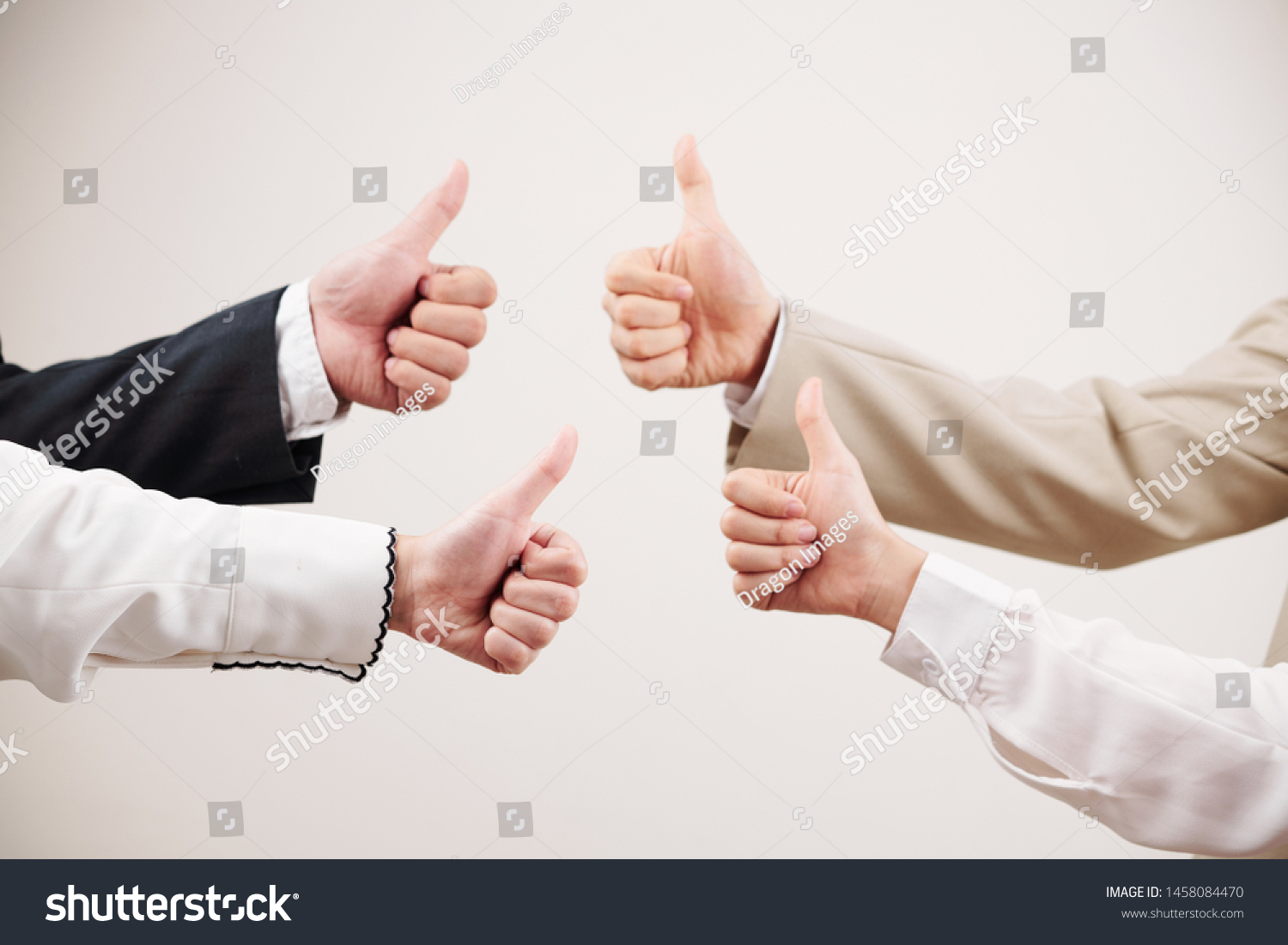 Close-up of business team showing thumbs up and symbolize success in business against the white background #1458084470